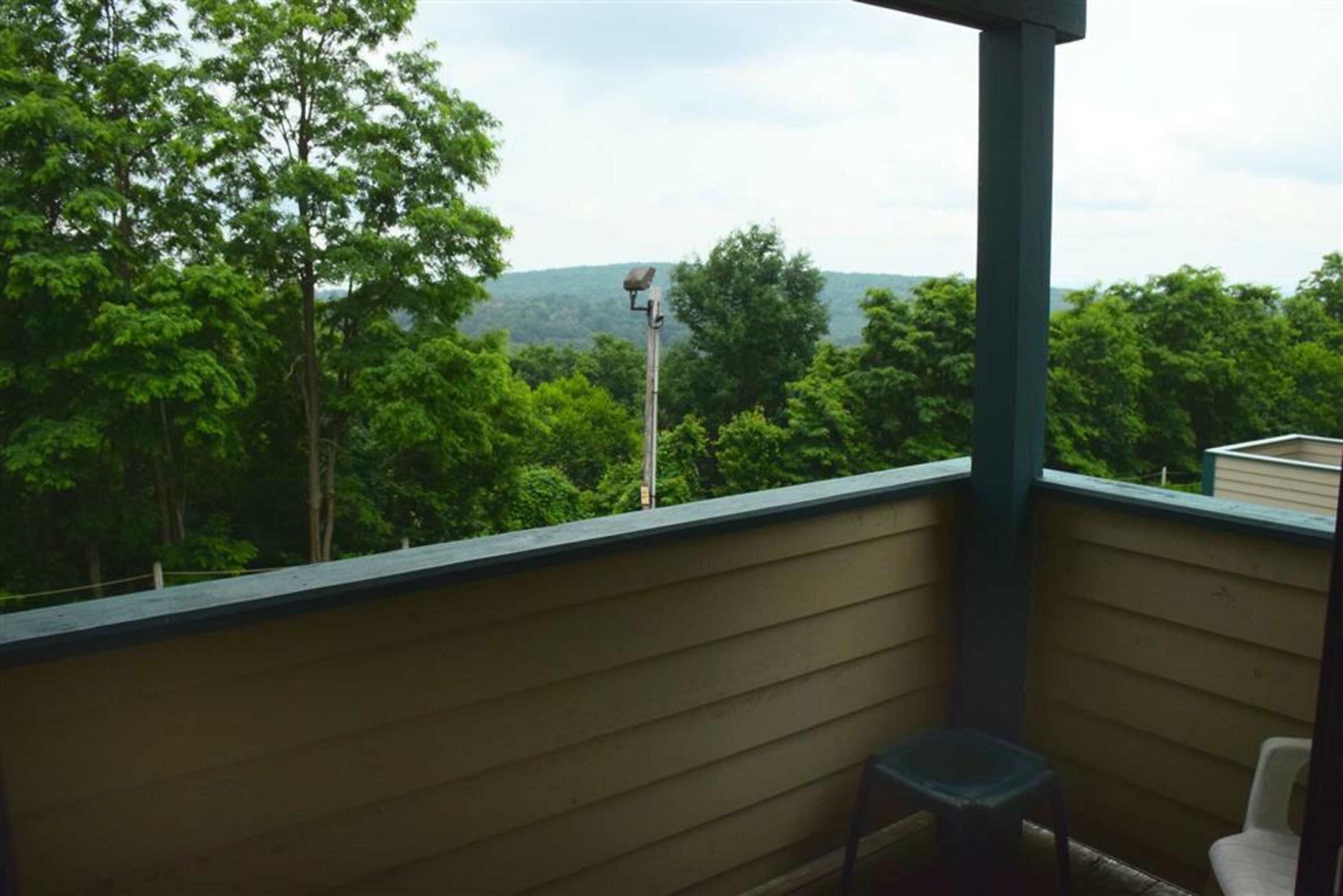 image Private deck with wooded mountain views—perfect for morning coffee or evening chats in the fresh air.
