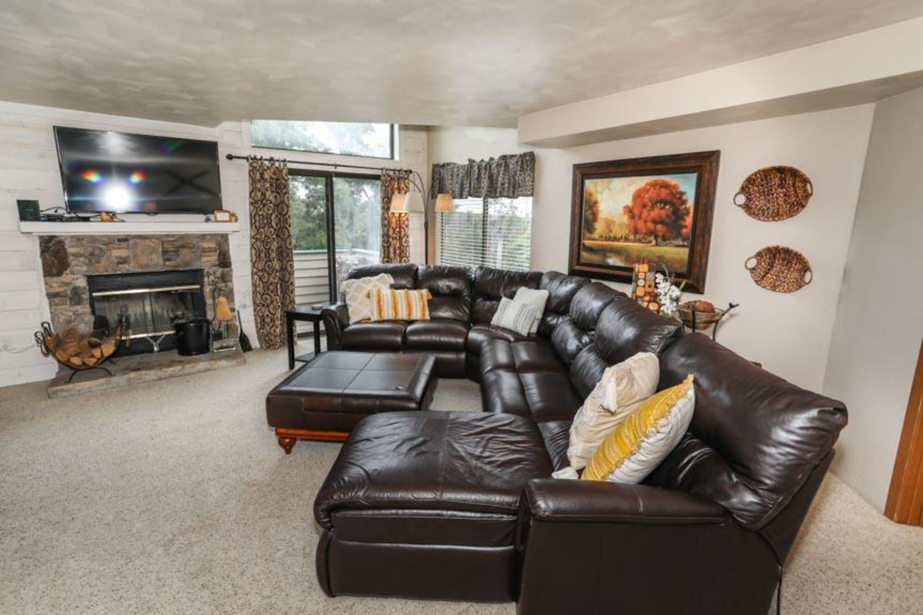 image Spacious living room with leather seating, and flat-screen Smart TV —perfect for relaxing after the slopes.