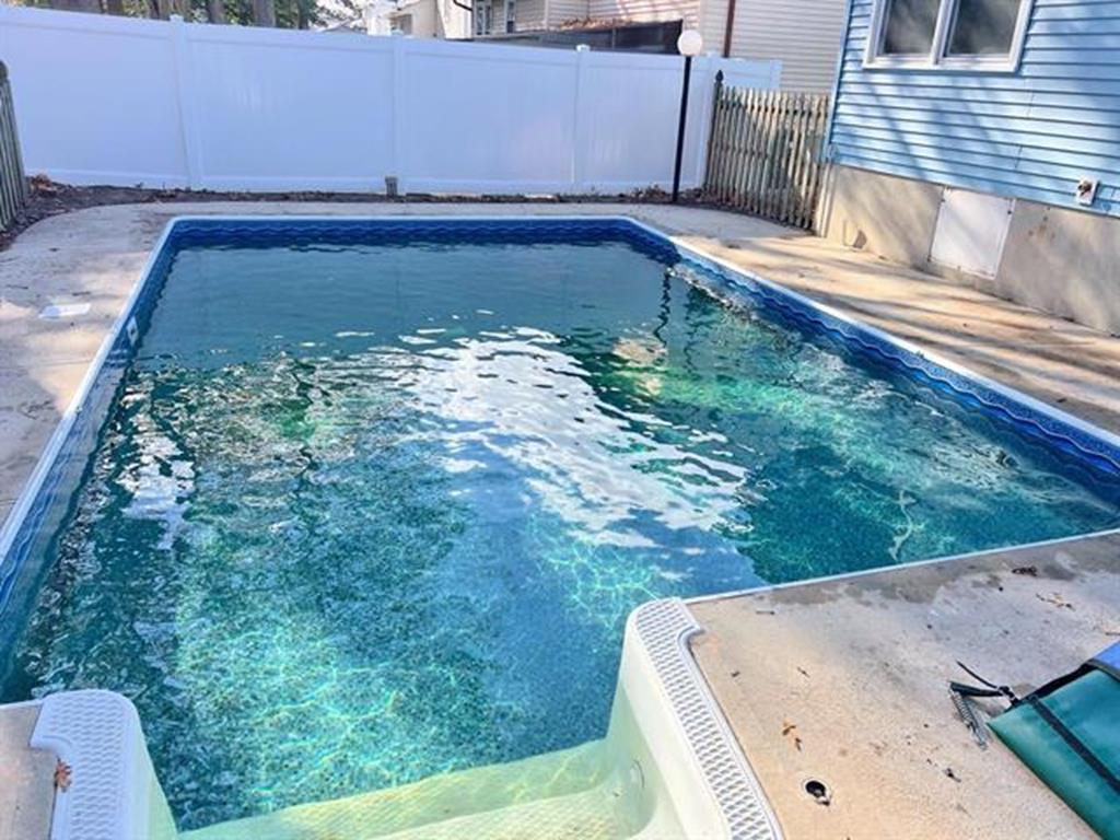 image Cool off in your private in-ground pool, a sunlit oasis perfect for lazy afternoons and refreshing dips.