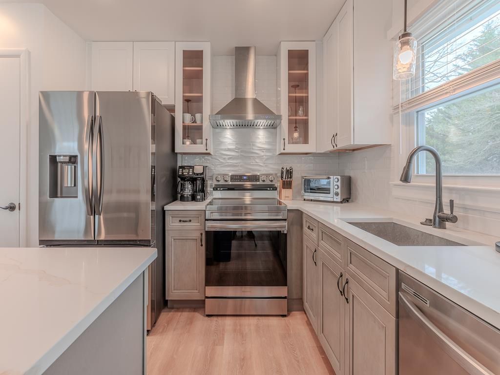 image Sleek and fully equipped, the kitchen features stainless steel appliances and elegant finishes for effortless vacation cooking.