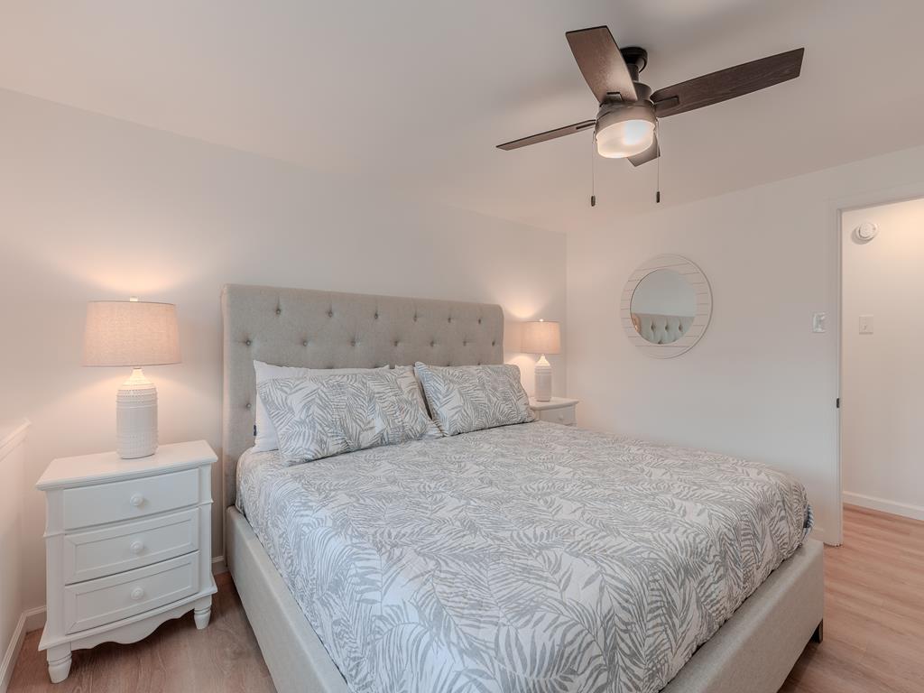 image Wake up refreshed in this airy room, featuring plush bedding, soft lighting, and a coastal-inspired palette.