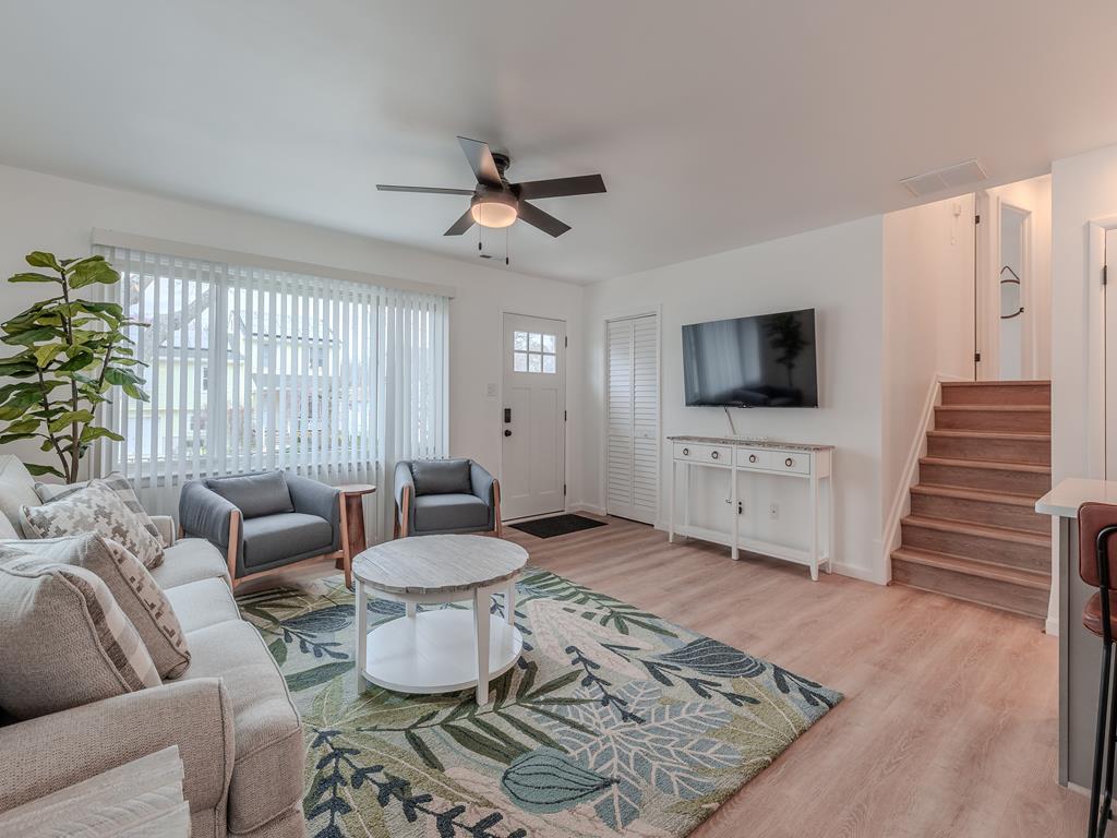 image Bright and welcoming — the living room flows effortlessly into the dining and kitchen areas, ideal for family time or cozy movie nights.