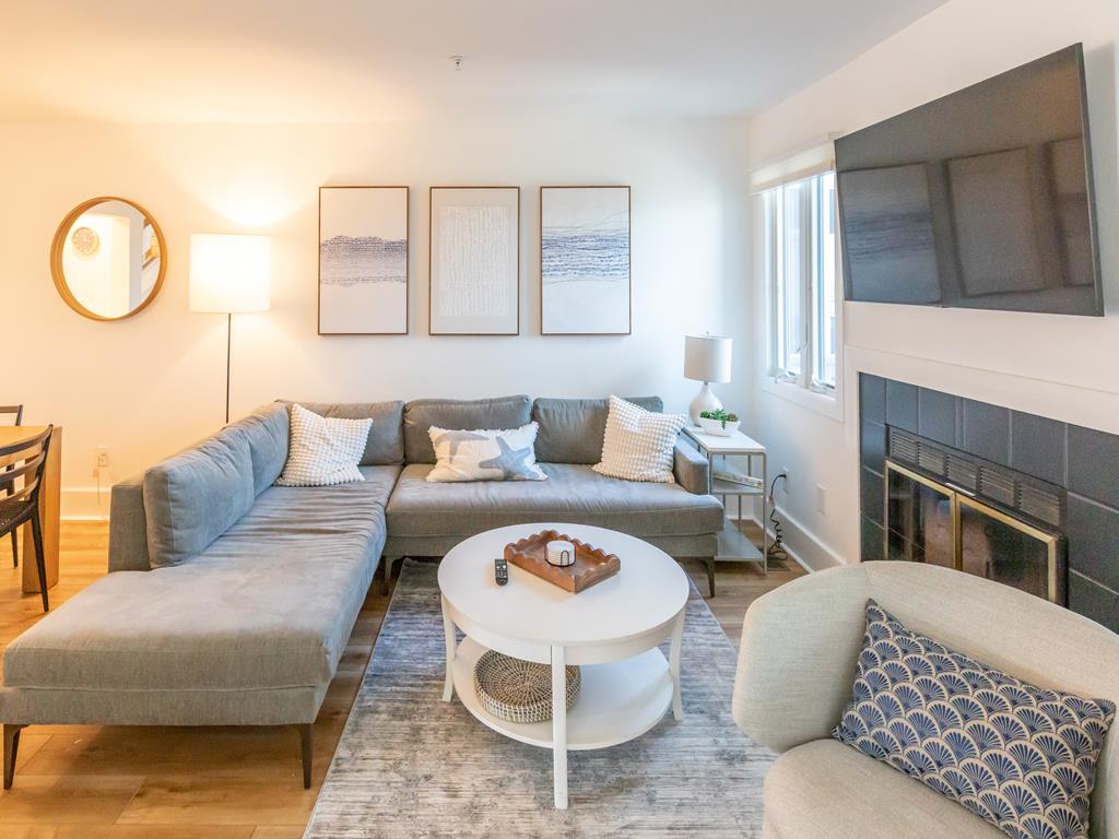 image Relax in the cozy living room adorned with stylish decor and natural light.