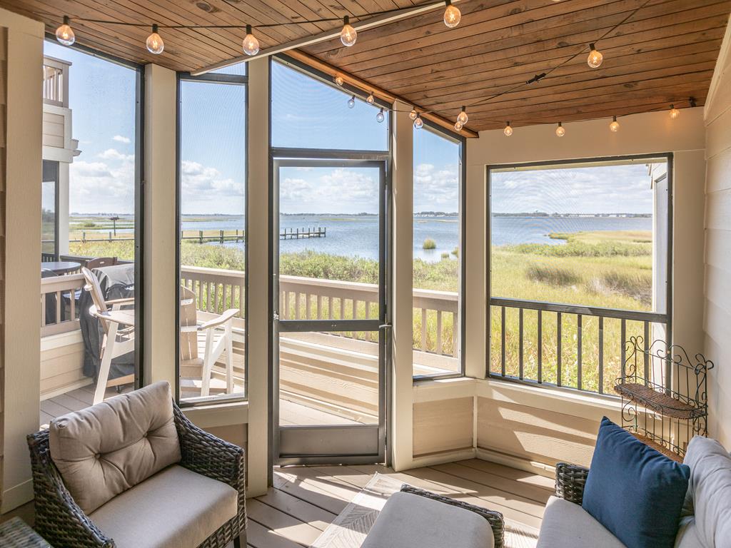 image Enjoy tranquil moments in the screened porch, where you can soak in stunning views of the bay while savoring outdoor dining with the BBQ grill.