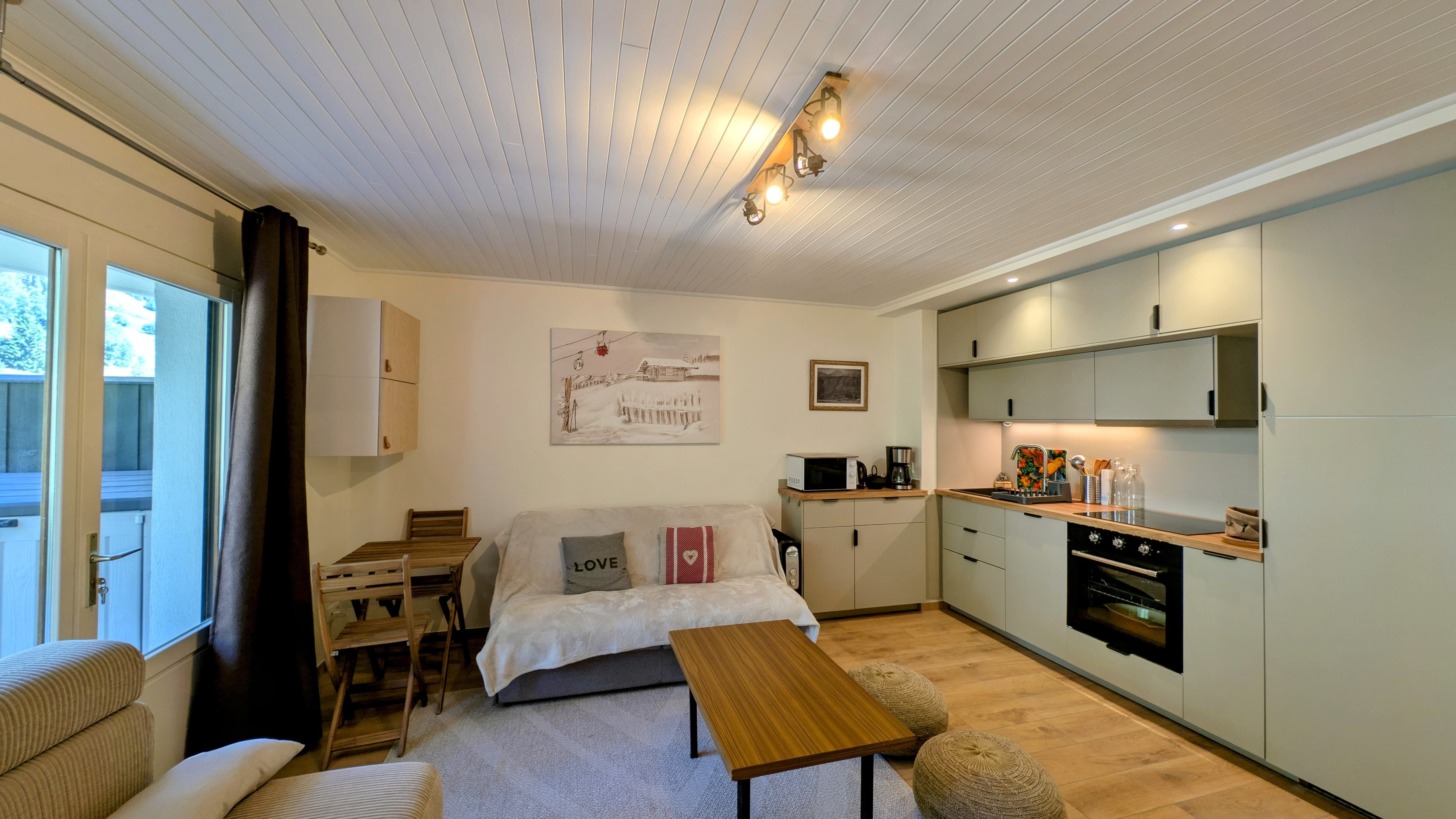 image Open-plan living and dining area with a warm alpine style, perfect for relaxing after a day on the pistes.