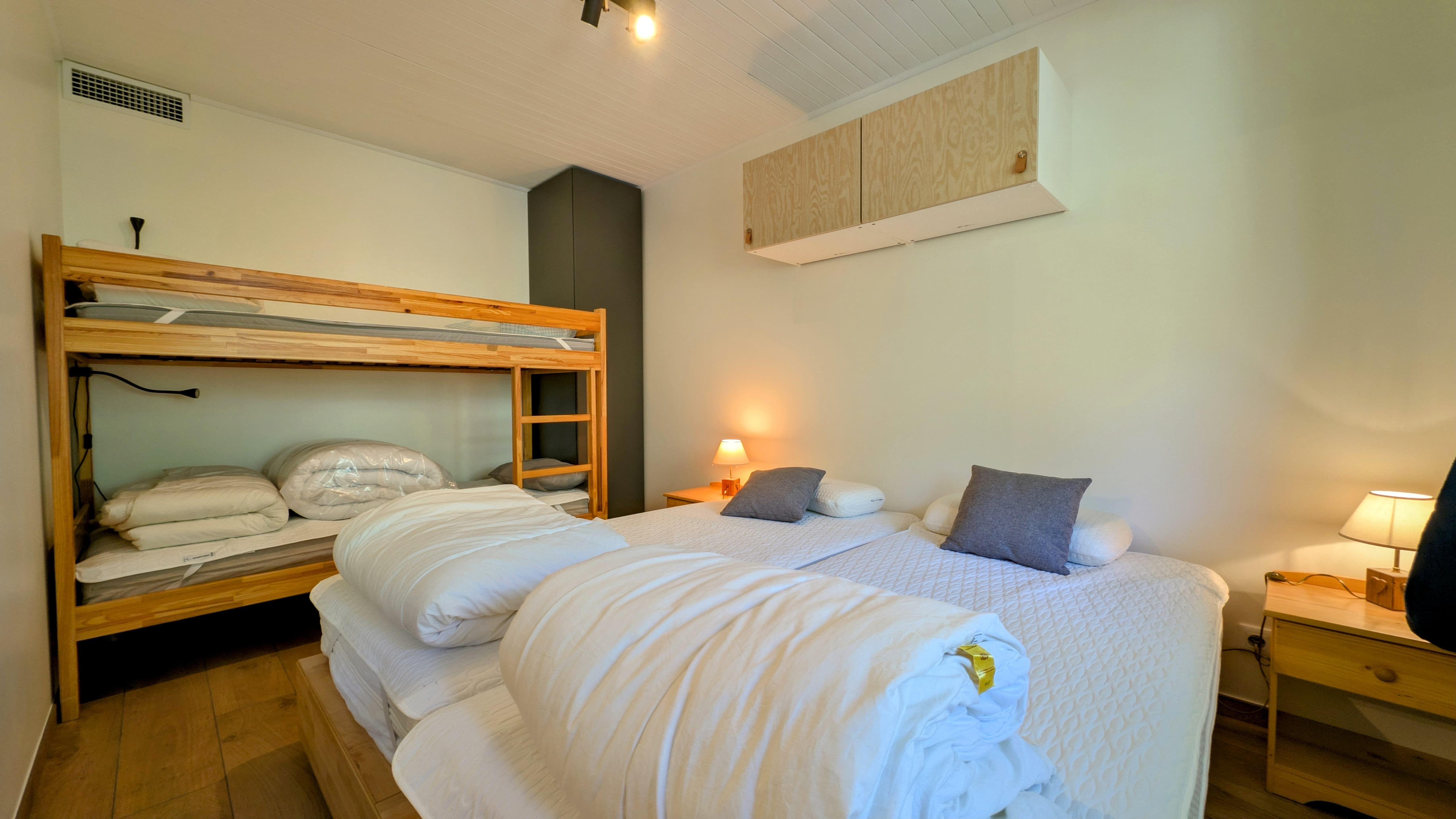 image Family-friendly second bedroom with a double bed and bunk beds — ideal for kids or friends sharing.