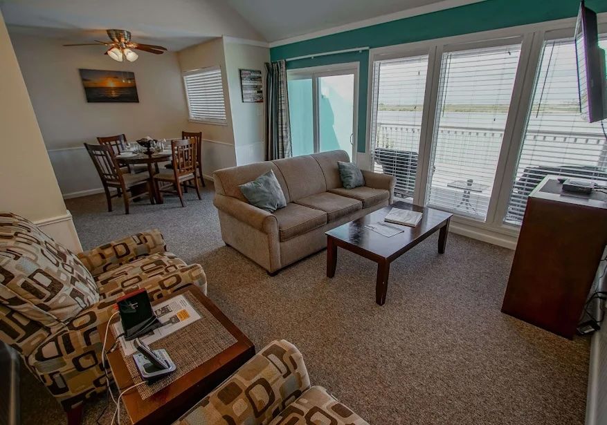 image Inviting living space filled with natural light and warm coastal charm, perfect for unwinding after a day by the bay.