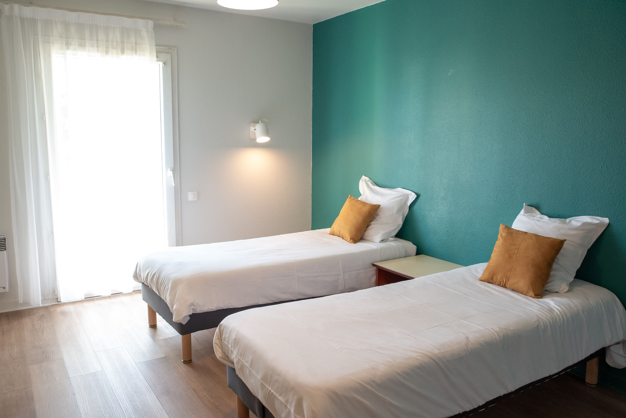 image The twin-bed sleeping area is filled with natural light for a pleasant, restful atmosphere.