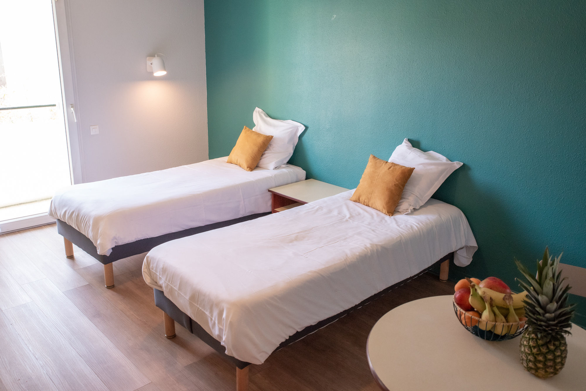 image A bright studio layout with twin beds, offering a comfortable space to relax and recharge.