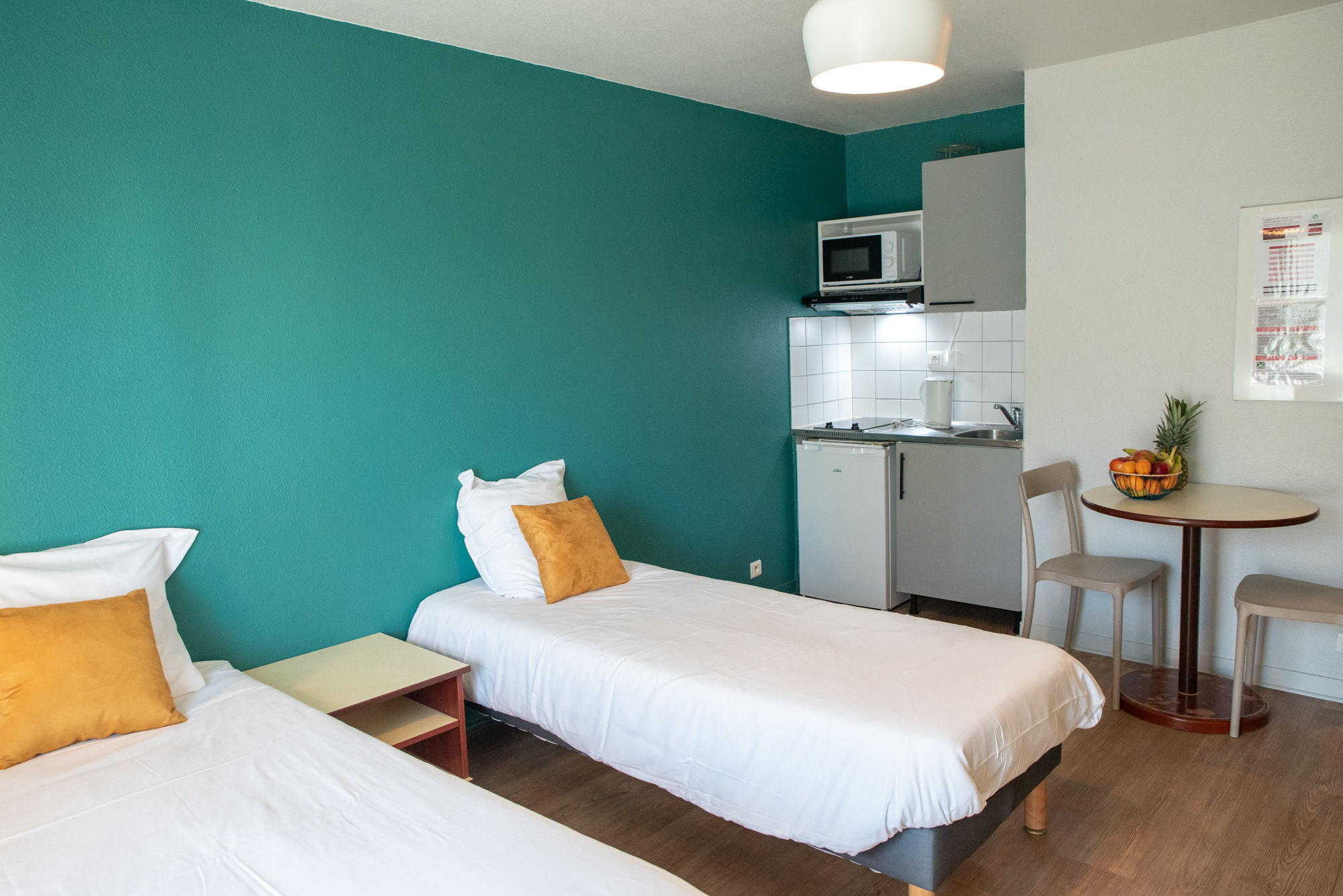 image The open studio setup combines twin beds and living space for an easy, functional stay.