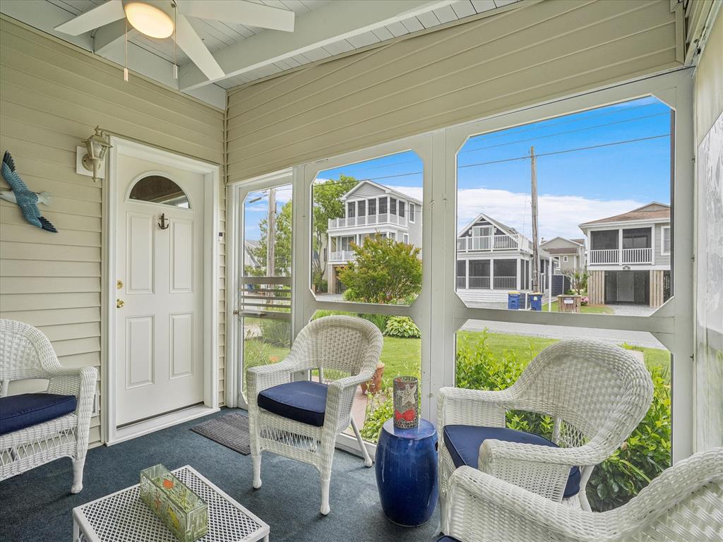 image Step into the inviting screened porch, perfect for relaxing with a good book while taking in views of the landscaped yard.