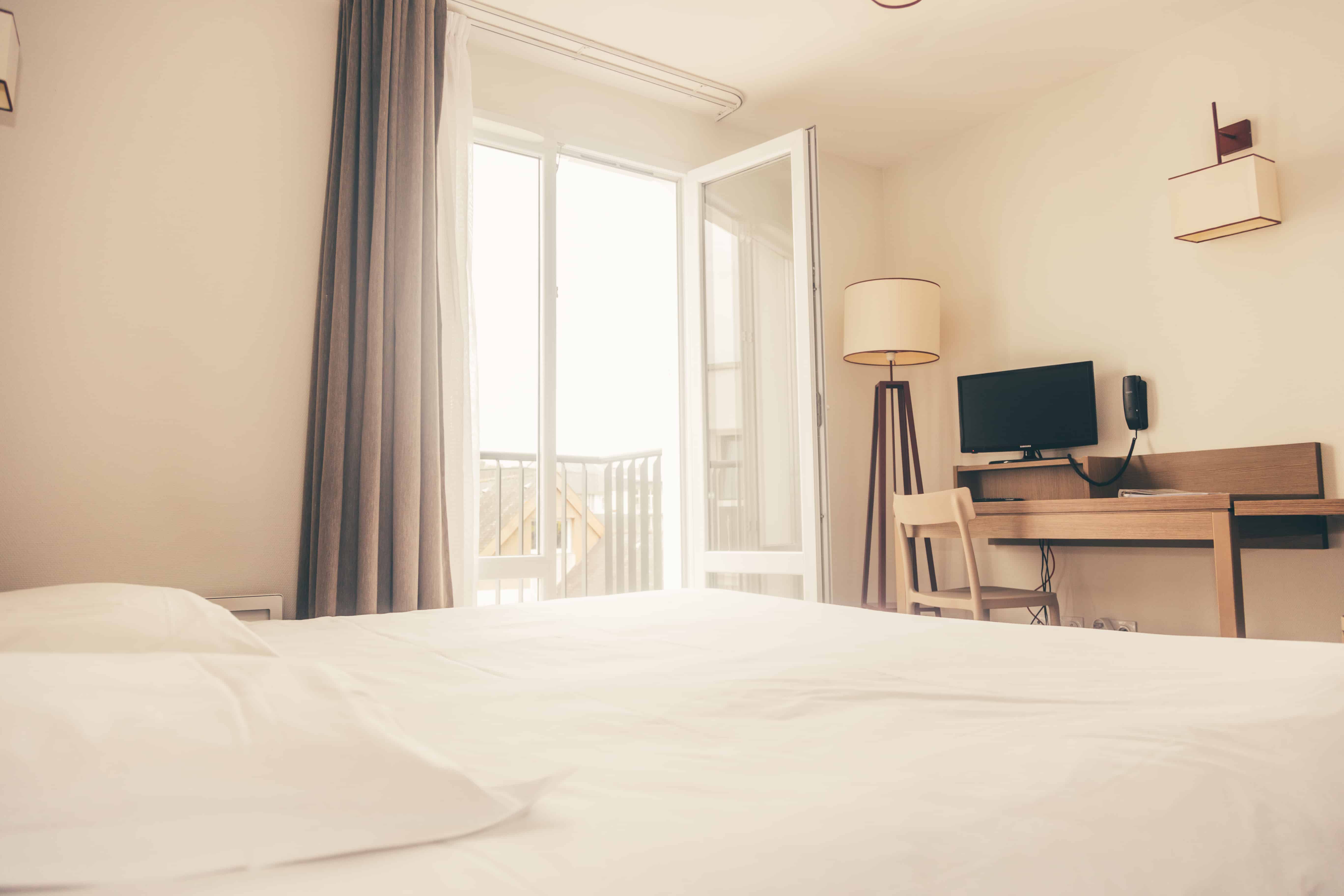 image The bedroom offers morning light, soft linens, and a quiet work space for your day in the city.