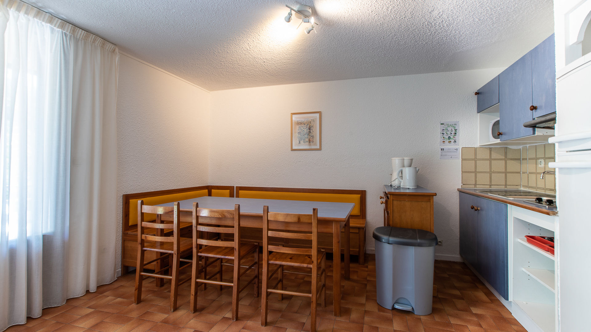 image Bright dining area opening onto the kitchen, perfect for family meals.