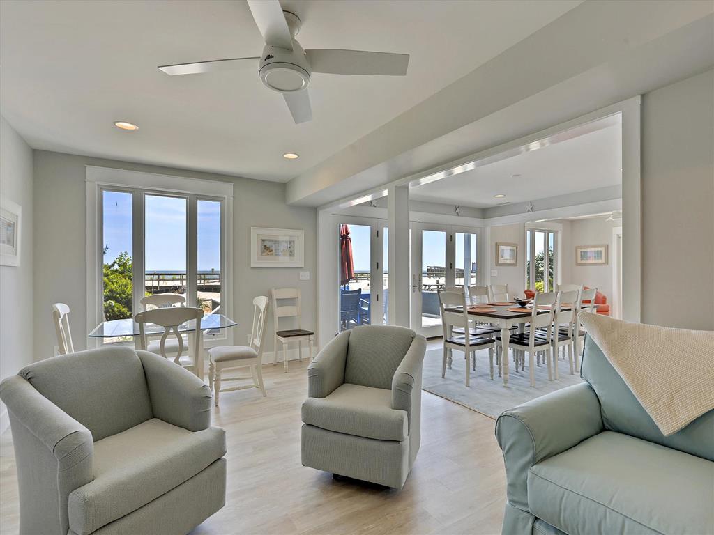 image Unwind in the bright living area, where comfortable seating meets beachside charm.