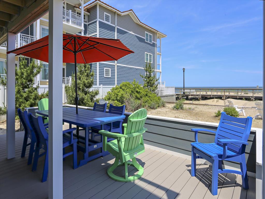 image Gather around this vibrant outdoor dining set and soak up the sun under a colorful umbrella.