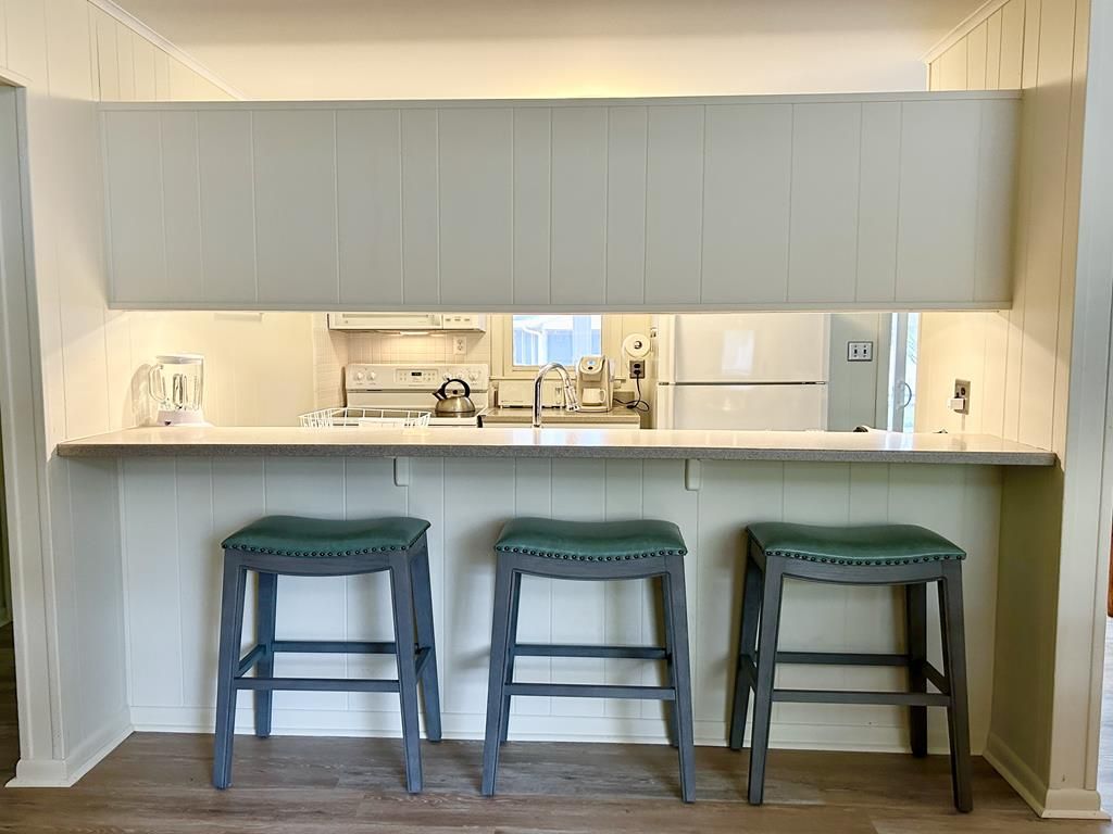 image Gather at the sleek kitchen island with comfortable seating, ideal for sharing meals and laughter.