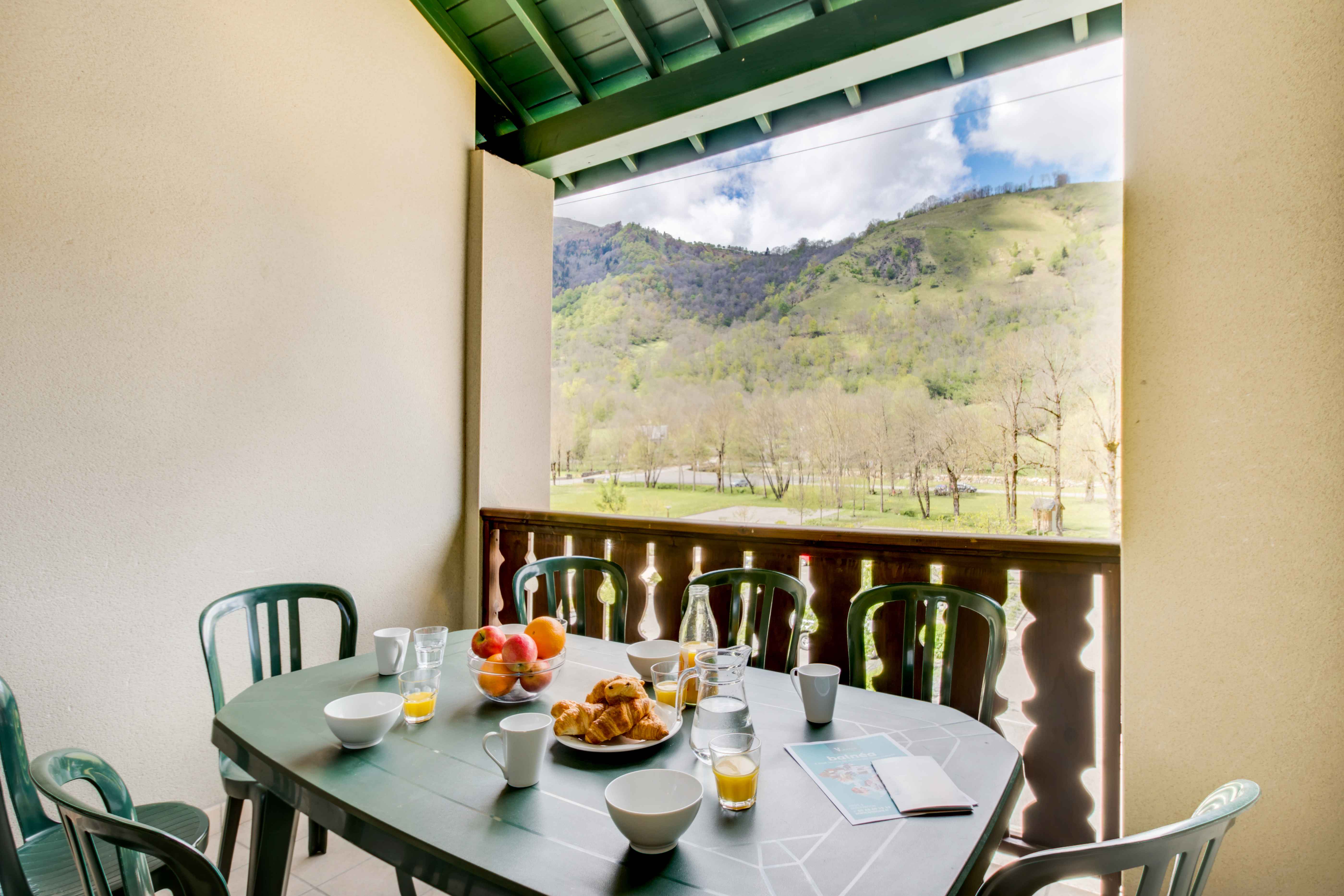 image Private balcony with outdoor dining set and breathtaking views of the surrounding Pyrenees. Enjoy breakfast in the morning sun or unwind with a glass of wine while taking in the mountain air.