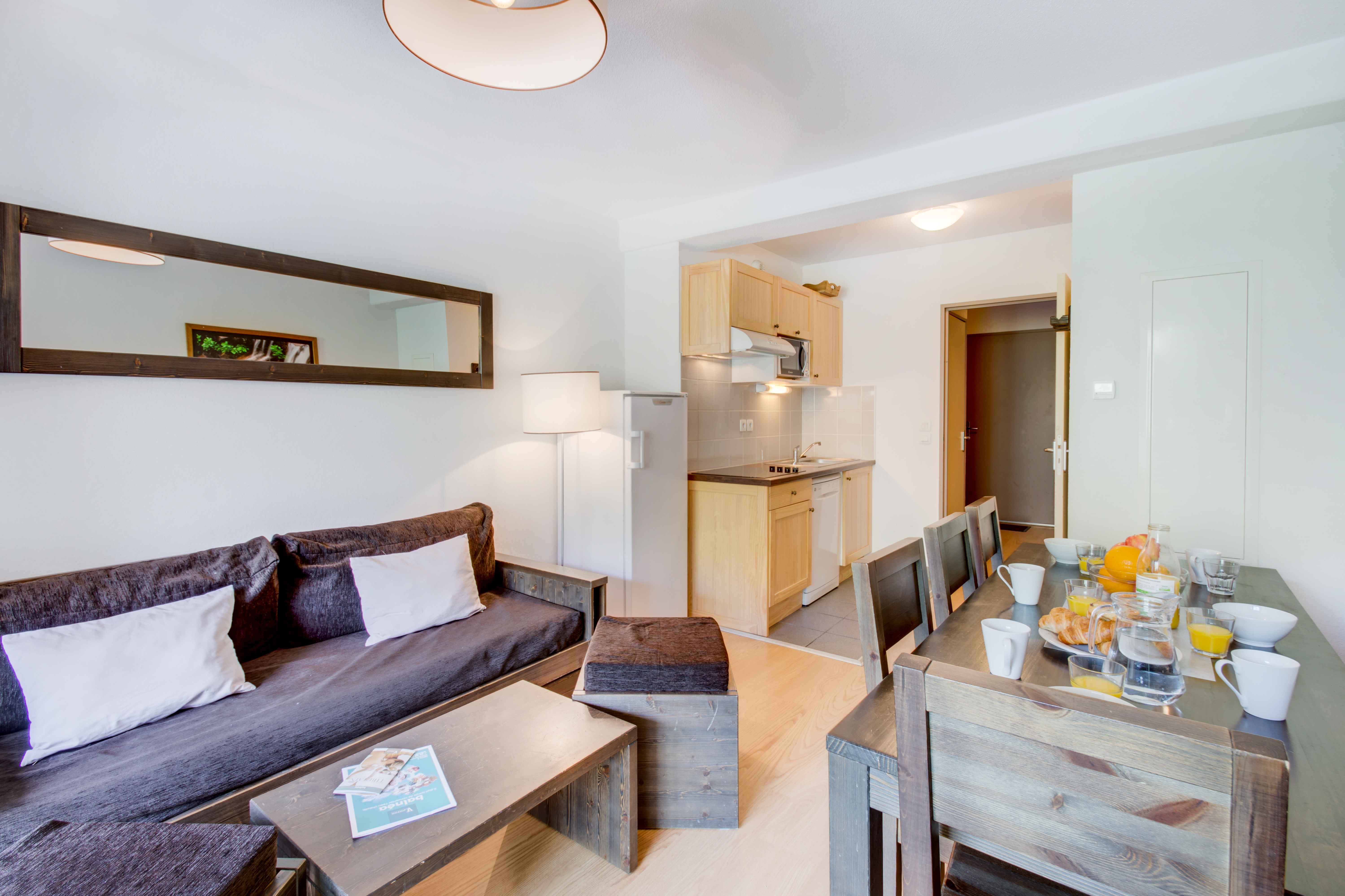image Spacious and welcoming living area with a comfortable sofa bed, flat-screen TV, and large windows letting in natural light. The perfect place to relax, share meals, or plan your next adventure in the Pyrenees.