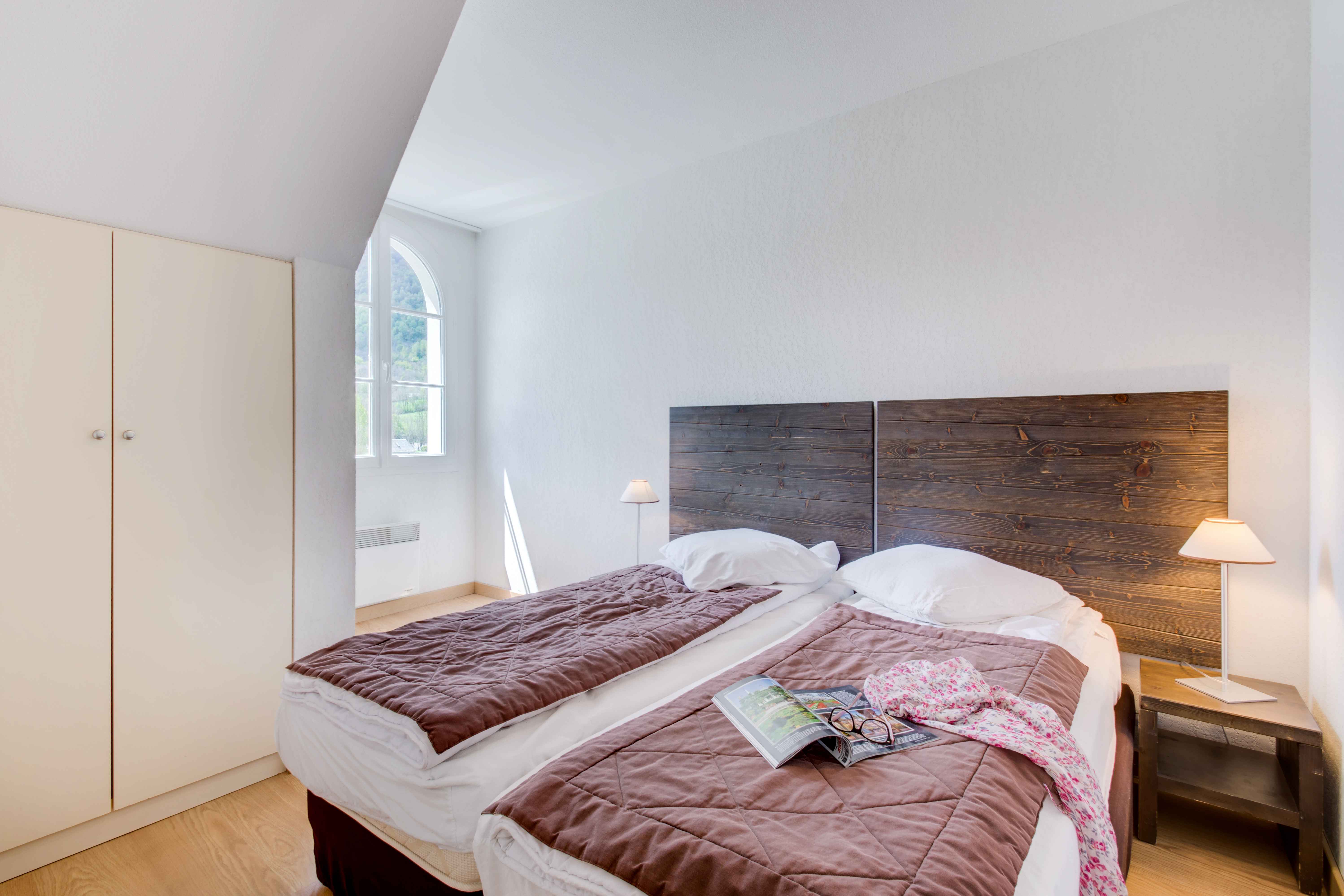 image Cozy bedroom with two single beds and soft linens — perfect for a restful night after a day in the mountains.