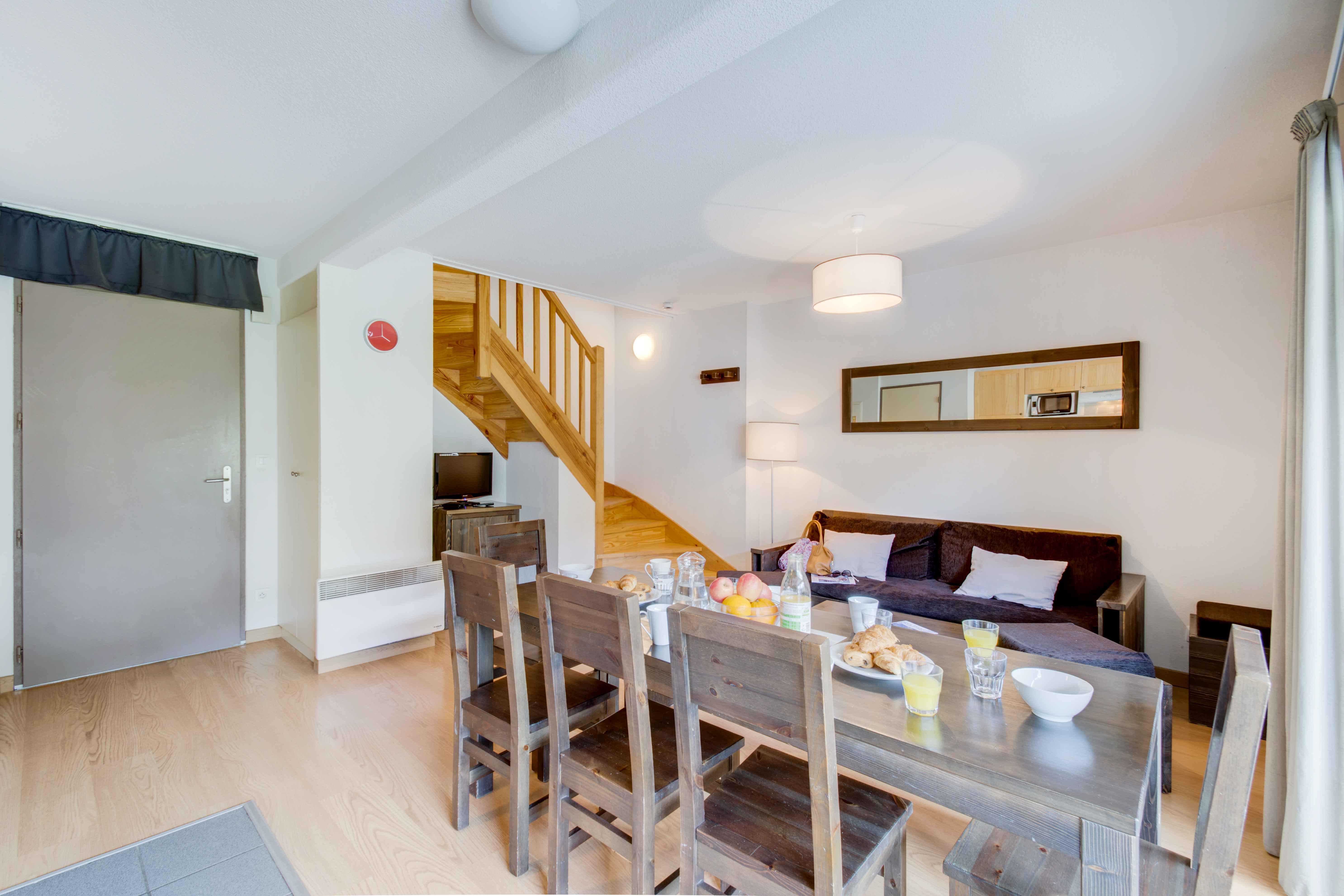 image Bright and spacious kitchen with a large dining table — perfect for enjoying home-cooked meals after a day in the mountains.