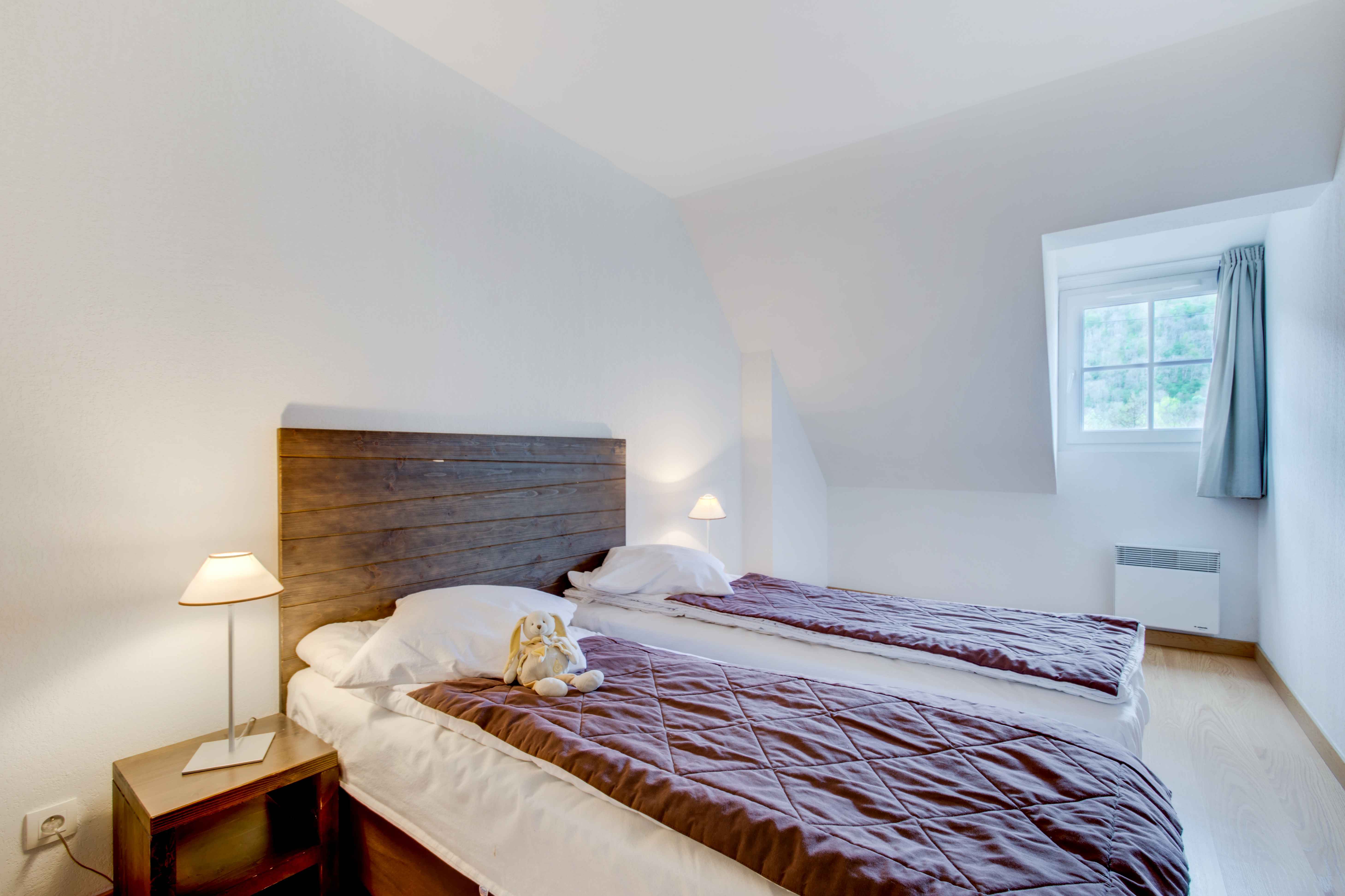 image Cozy twin bedroom with two single beds and a bright, airy feel — great for kids or travel companions.