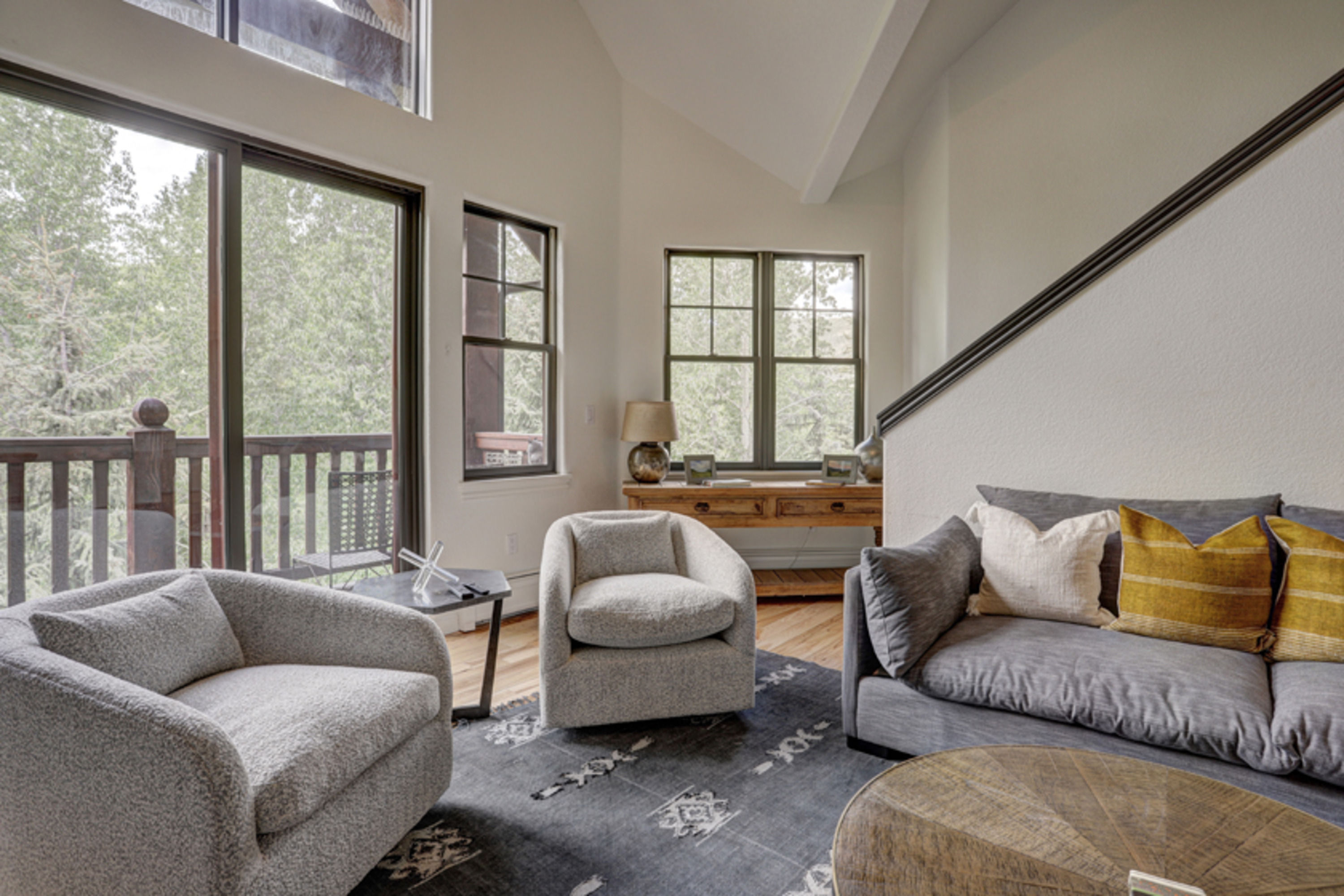 image An airy open-concept lounge invites slow mornings and quiet evenings beneath vaulted ceilings and alpine views.