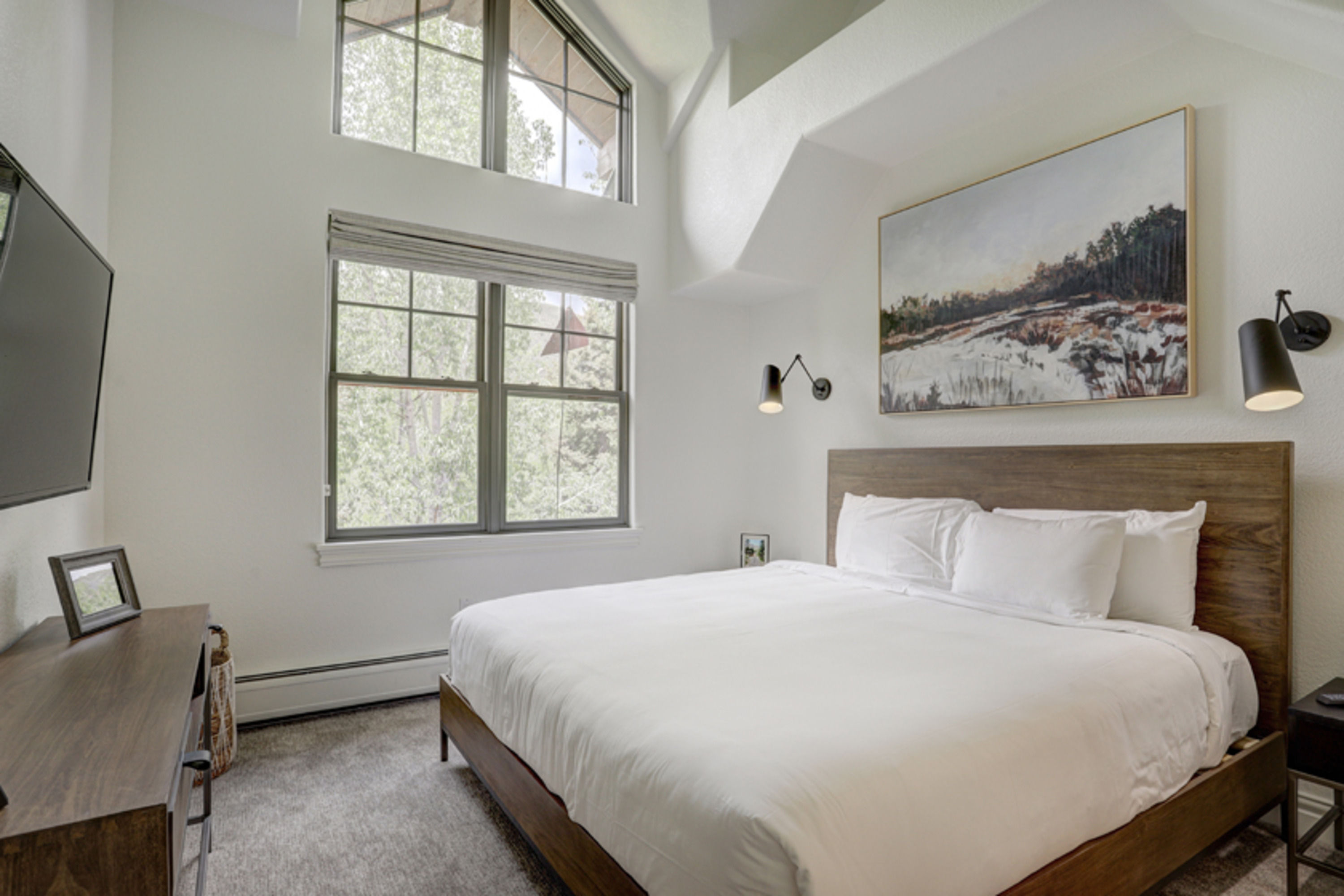 image The serene primary bedroom offers a peaceful retreat, wrapped in soft light and mountain-inspired design.