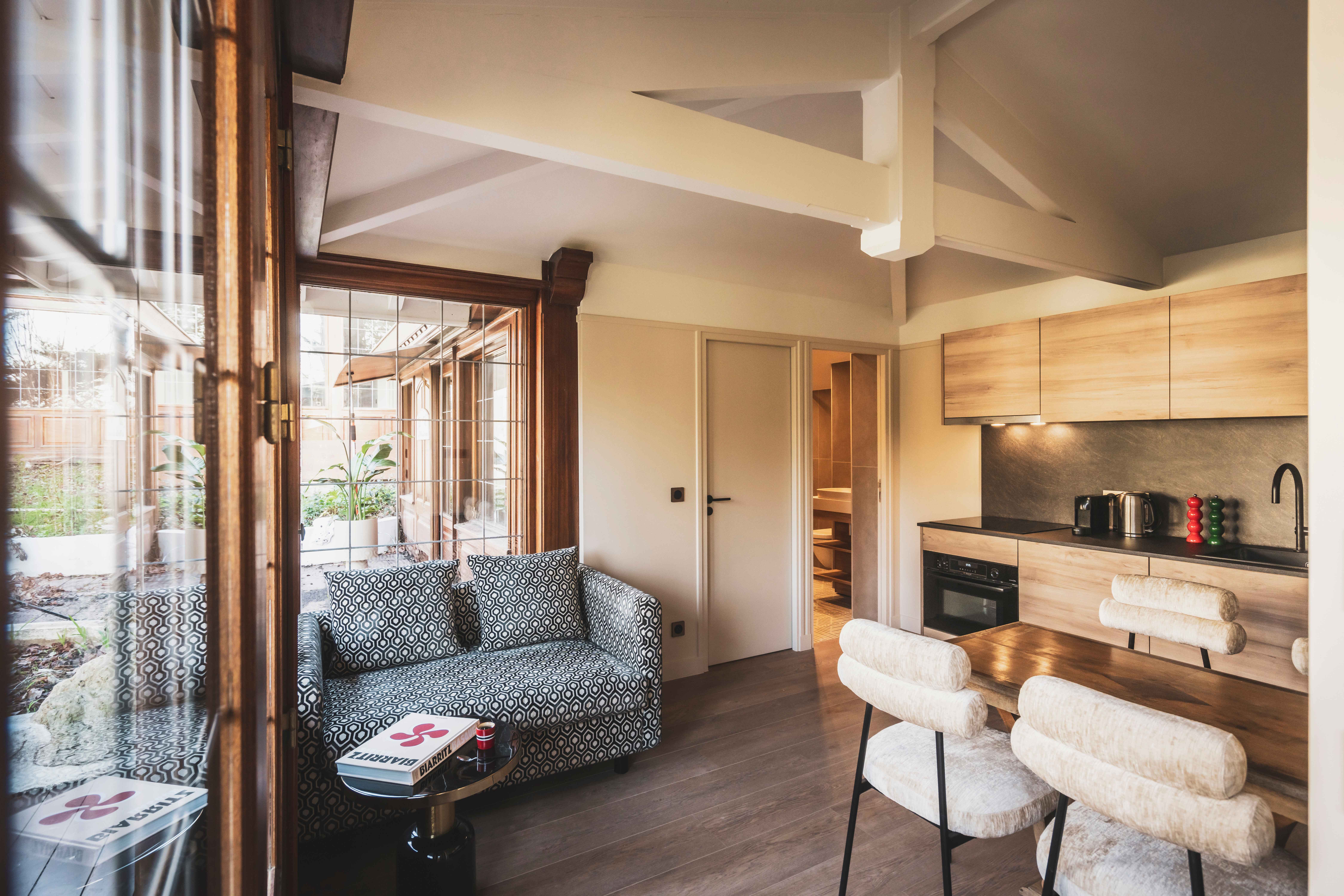 image A luminous open-plan space where wood tones and soft textures invite you to unwind after a day by the sea.