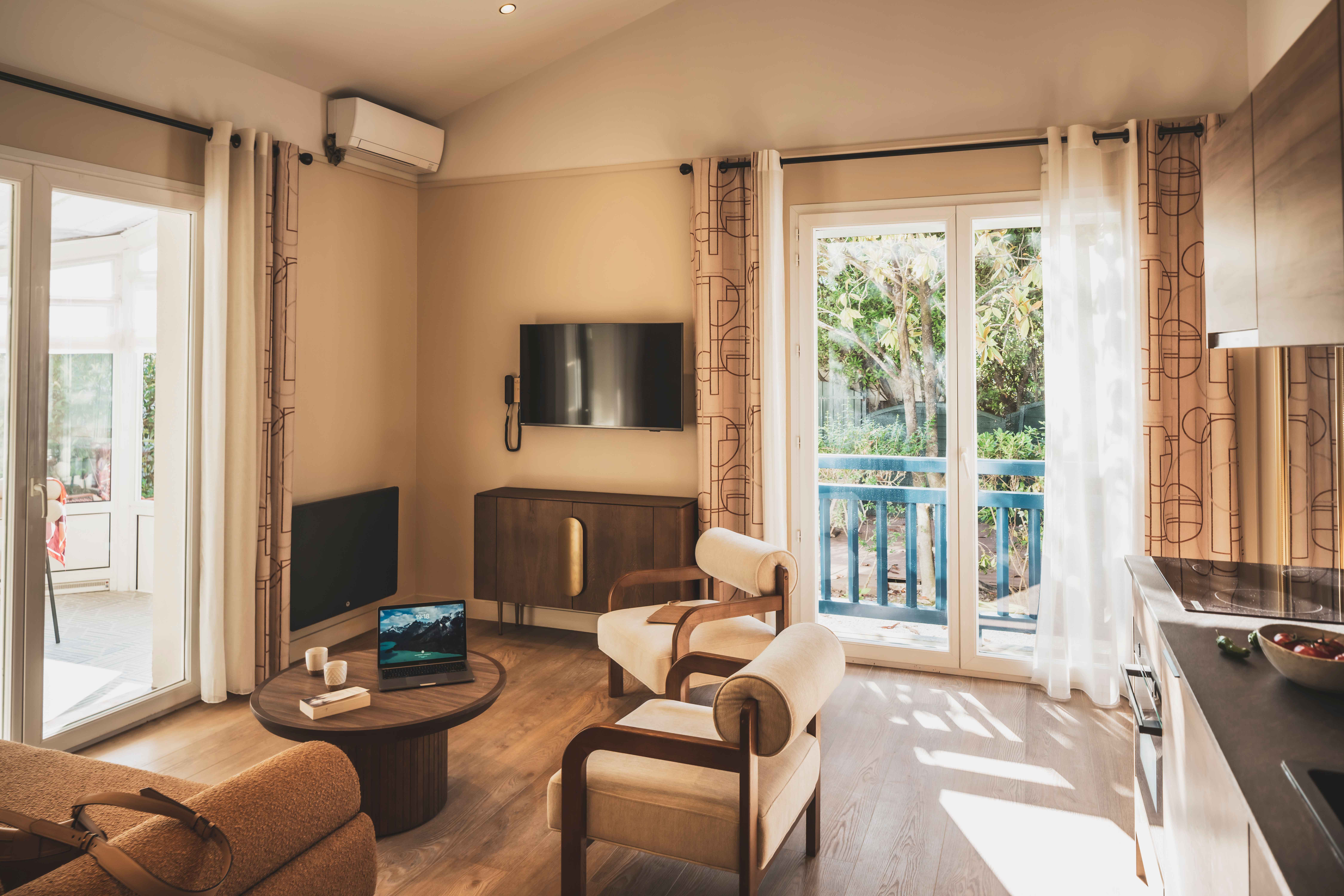 image Bright living area with lounge seating, dining space, and access to the terrace — ideal for relaxed mornings or cozy evenings in Saint-Jean-de-Luz.