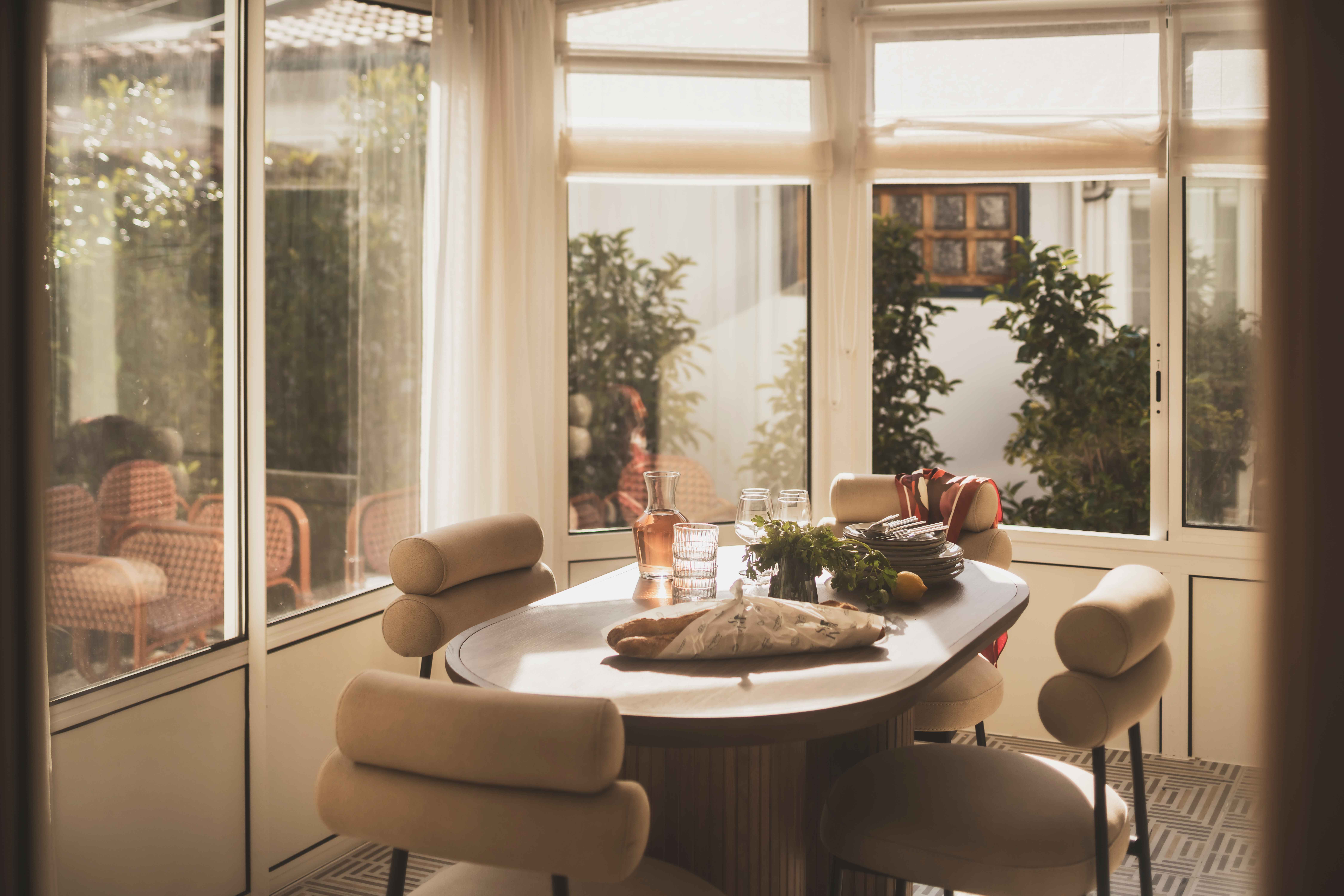 image A sunlit dining nook framed by greenery—perfect for slow breakfasts and lively evening conversations.