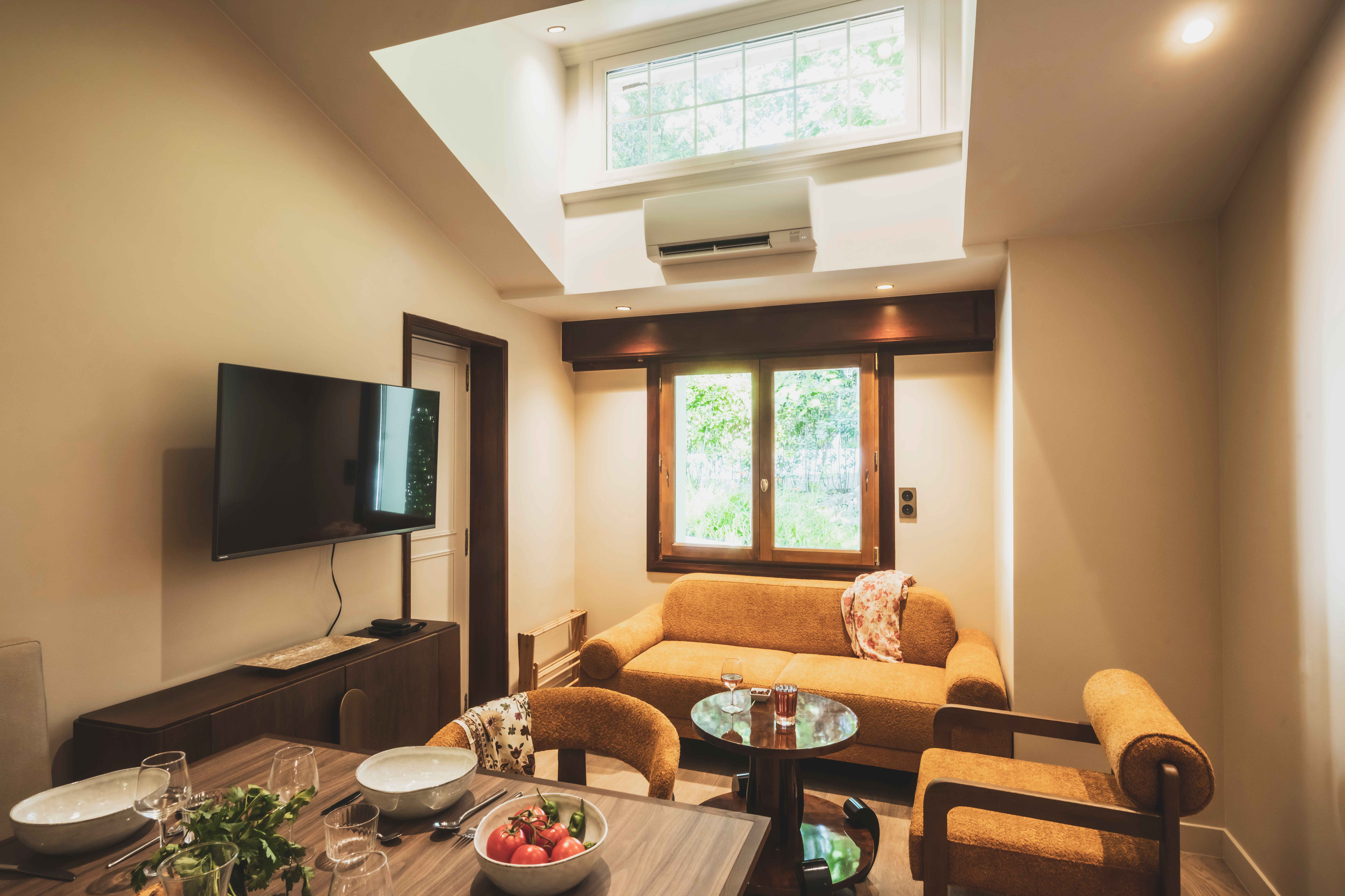 image Elegant and airy, the living space blends Art-Deco lines with modern comfort—perfect for relaxing after a day by the sea.