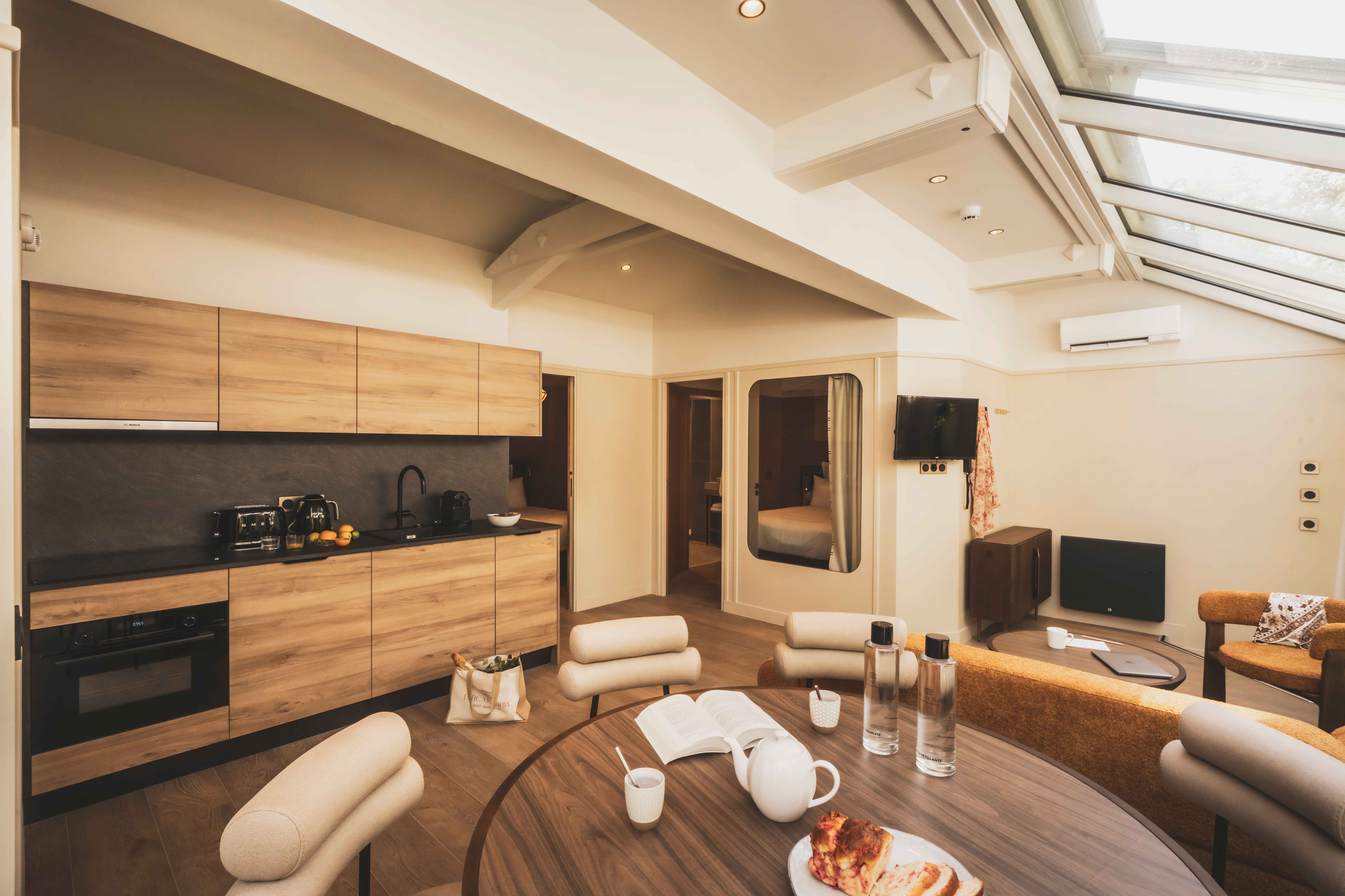 image A modern open kitchen and dining area, where warm wood tones create a cozy and welcoming feel.