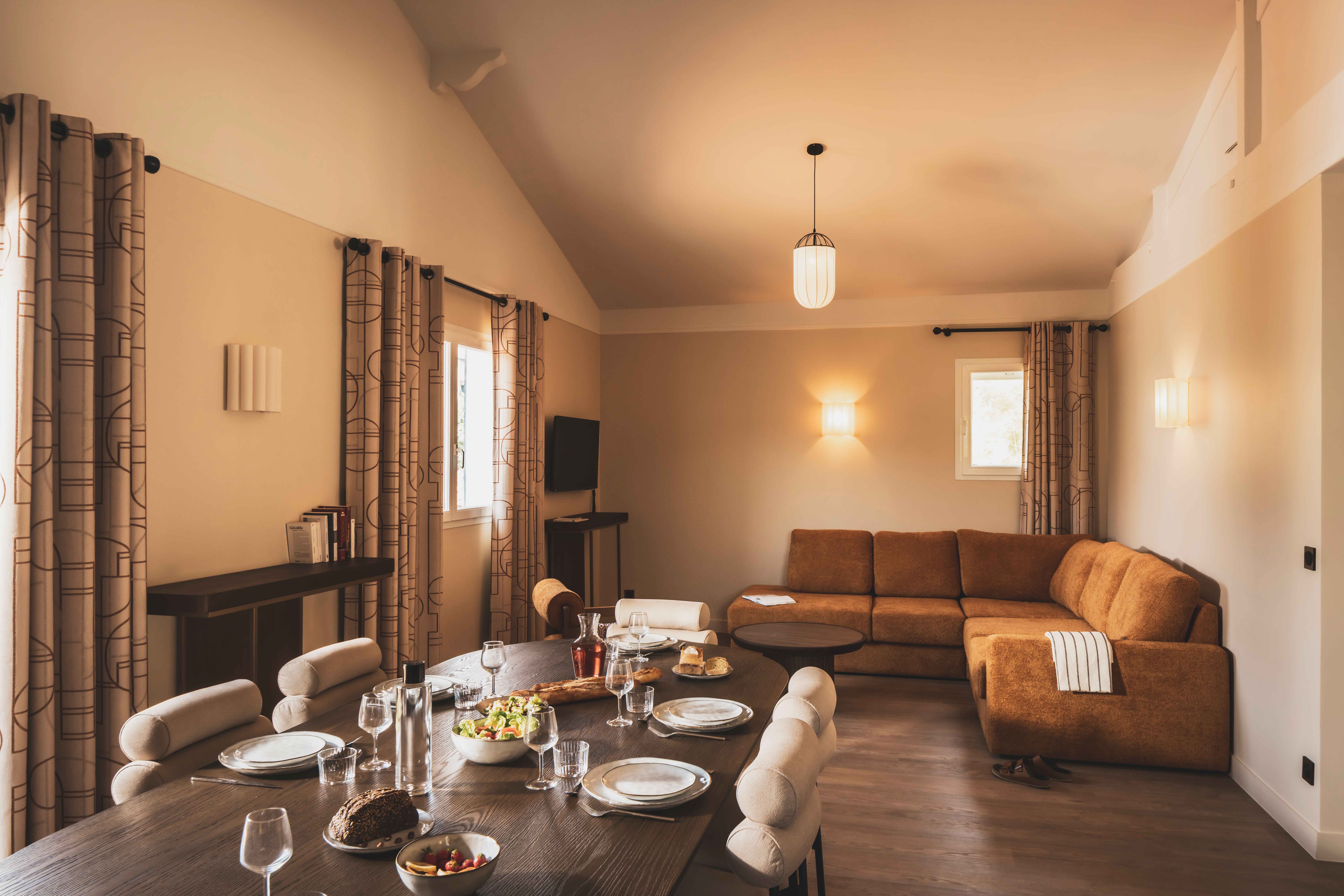 image A bright and spacious living area filled with natural light — perfect for relaxing or sharing meals together.