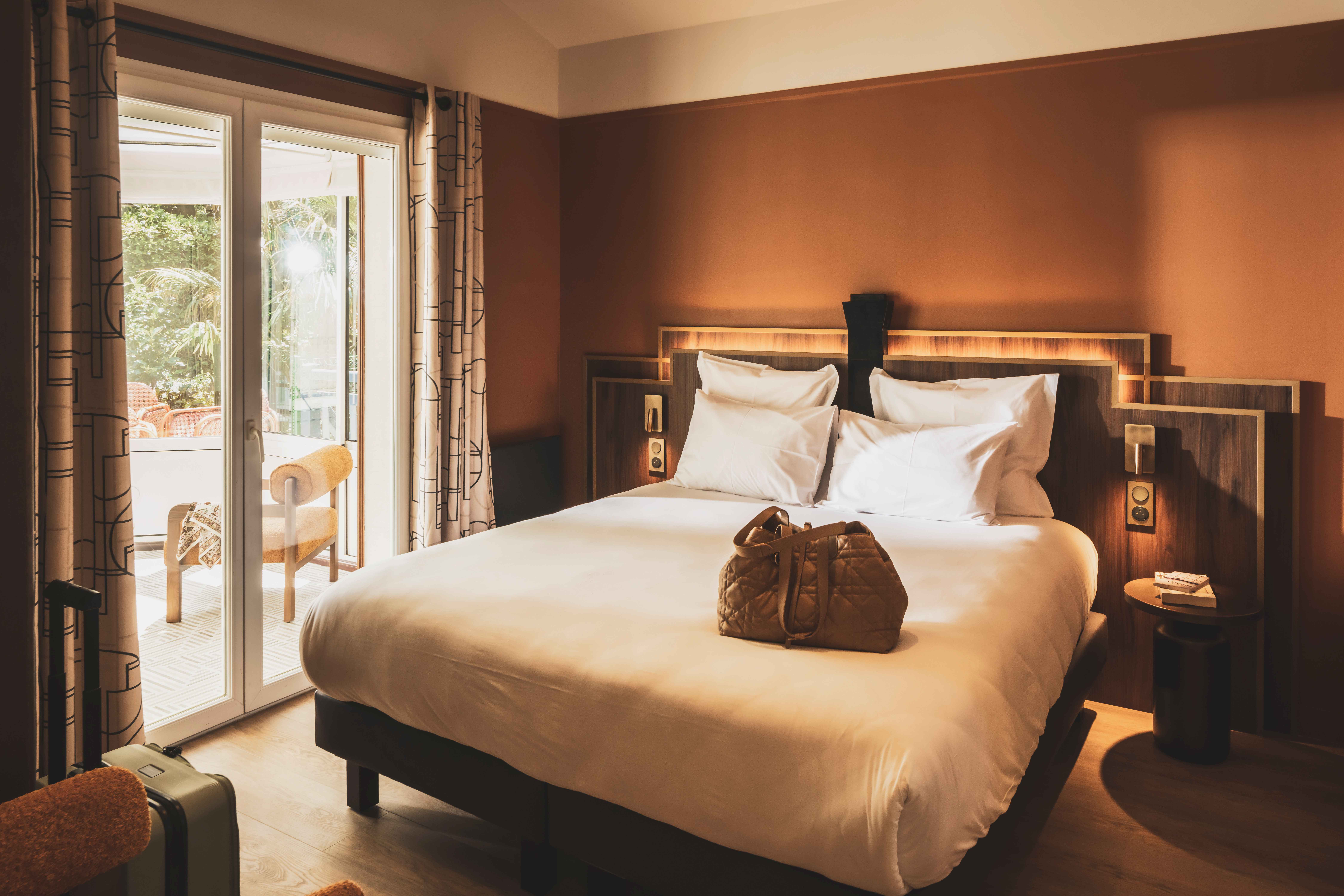 image A peaceful bedroom with soft tones and garden-inspired views, designed for restful nights and slow mornings.