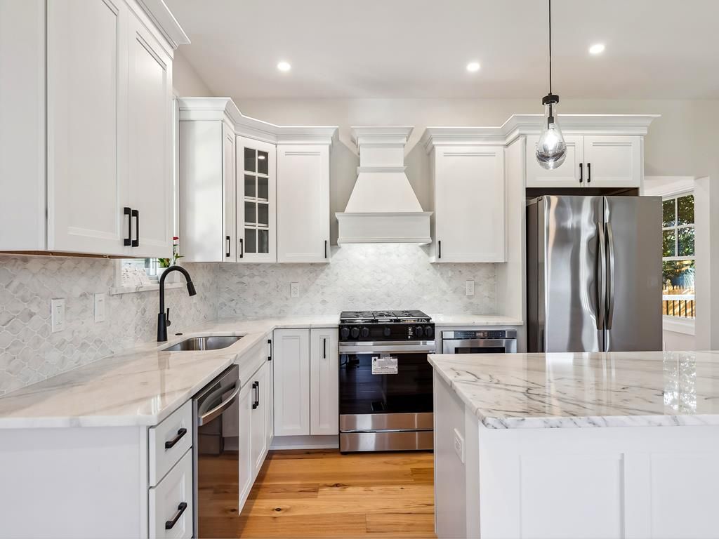 image Gourmet kitchen with marble countertops, stainless steel appliances, and plenty of storage for family meals.