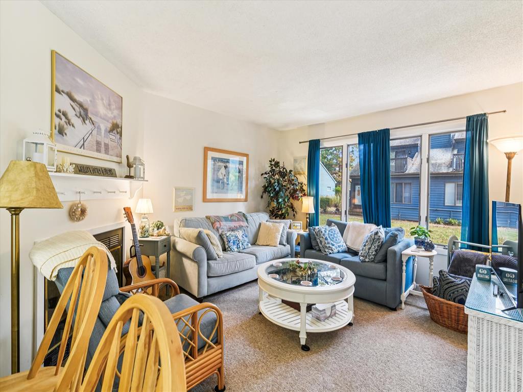 image Bright living area features a sofa, armchairs, and a round coffee table with decorative accents