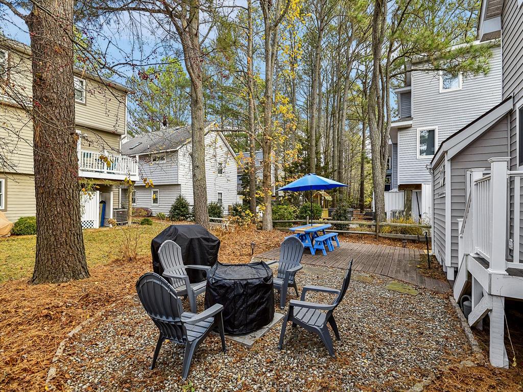image A charming gathering space in the backyard, complete with comfortable seating and picnic areas, perfect for outdoor entertaining.