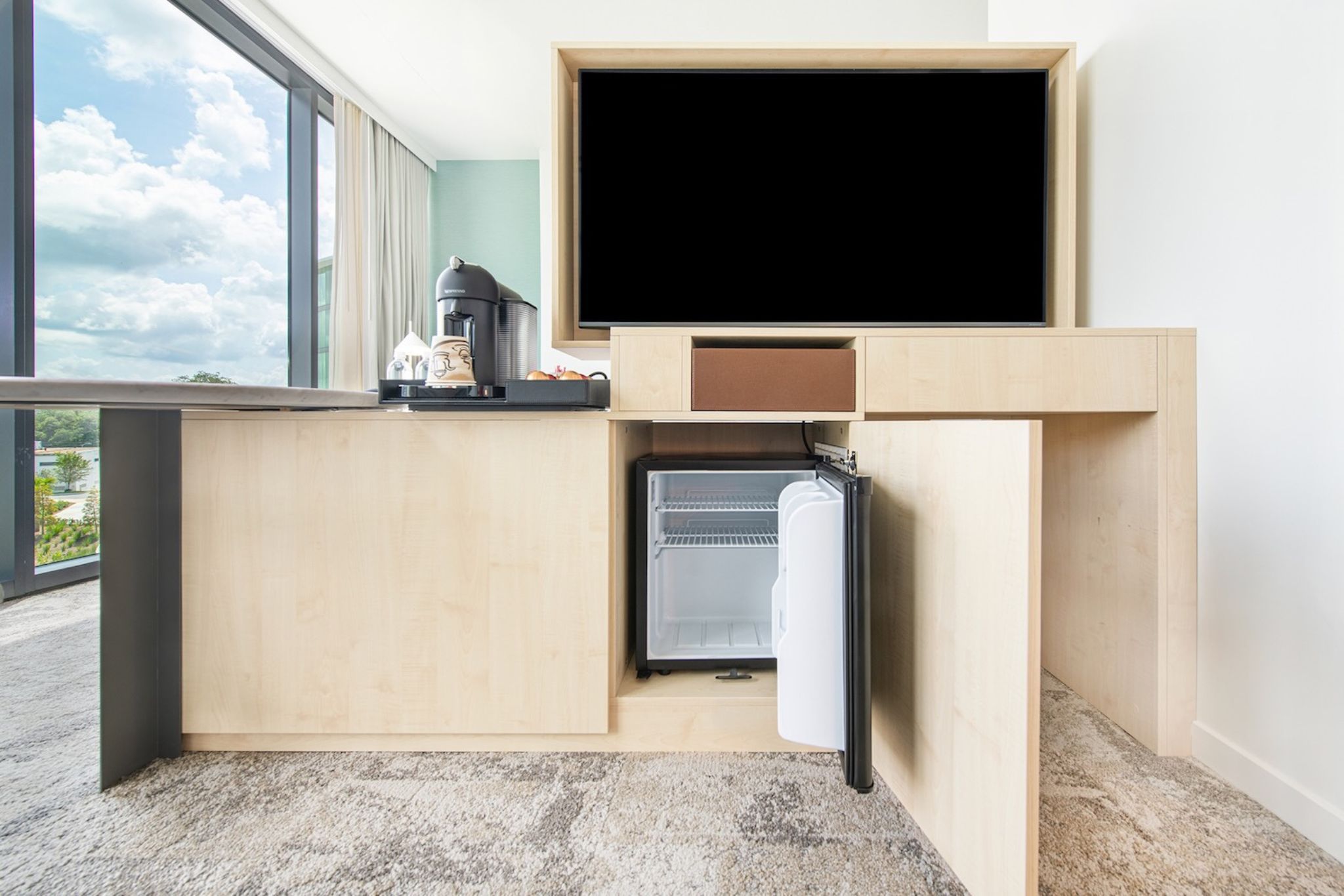 image Compact, clever, and stylish, the mini fridge keeps your snacks chilled and your coffee steaming.