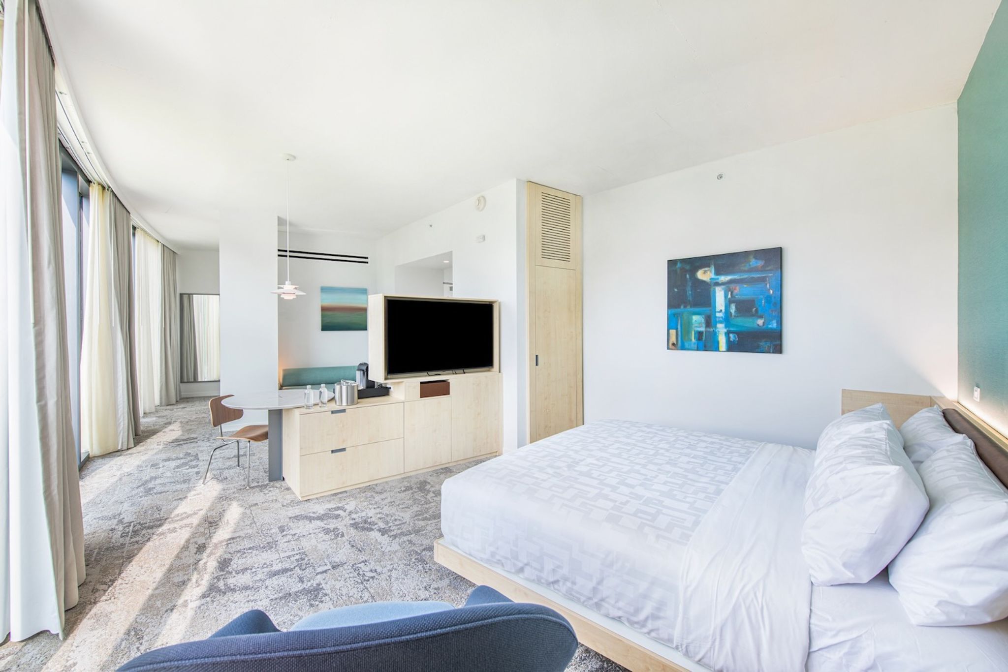 image Retreat to this spacious guestroom at Hotel Eleo, where elegant aesthetics and inclusive design invite you to unwind in comfort.