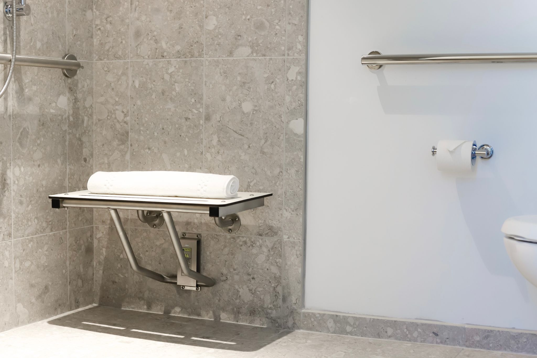 image Thoughtfully designed for comfort, the accessible features of this bathroom ensure a stress-free experience.