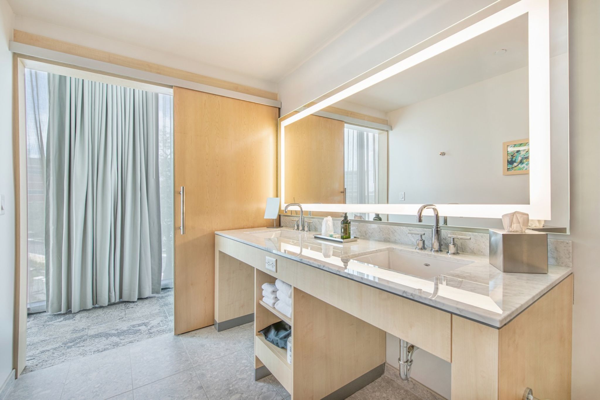 image A serene escape awaits in this chic lakeside bathroom, where natural light enhances the modern elegance.
