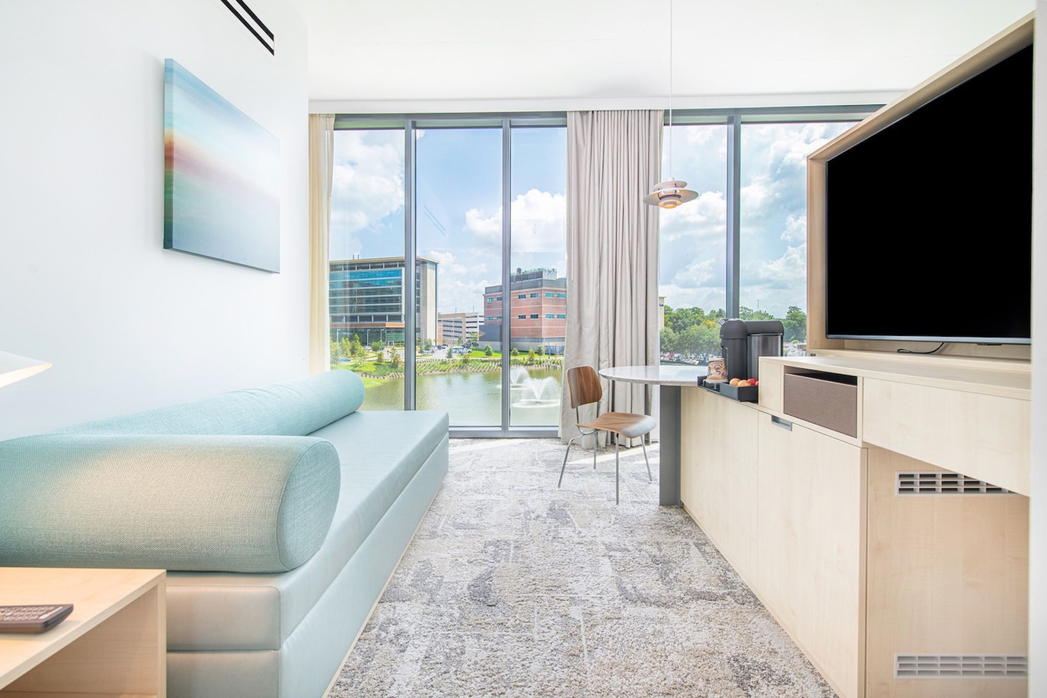 image Panoramic lake views blend seamlessly with modern furnishings in this chic living space, perfect for both relaxation and work.