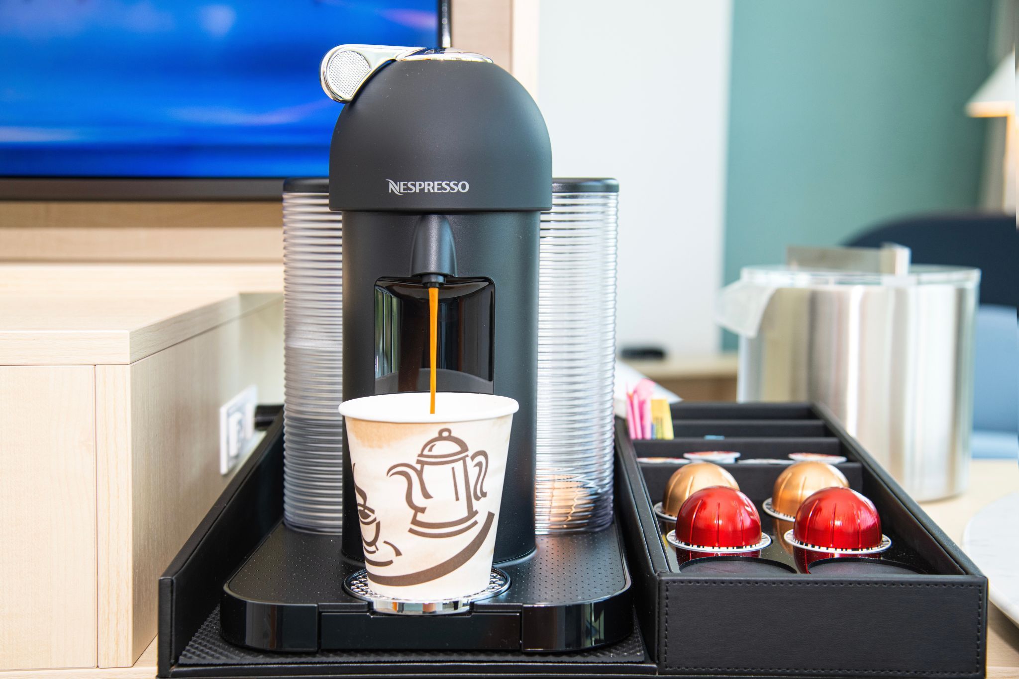 image Enjoy a rich coffee experience right in your room with the Nespresso machine, perfect for starting your day in comfort at Hotel Eleo.