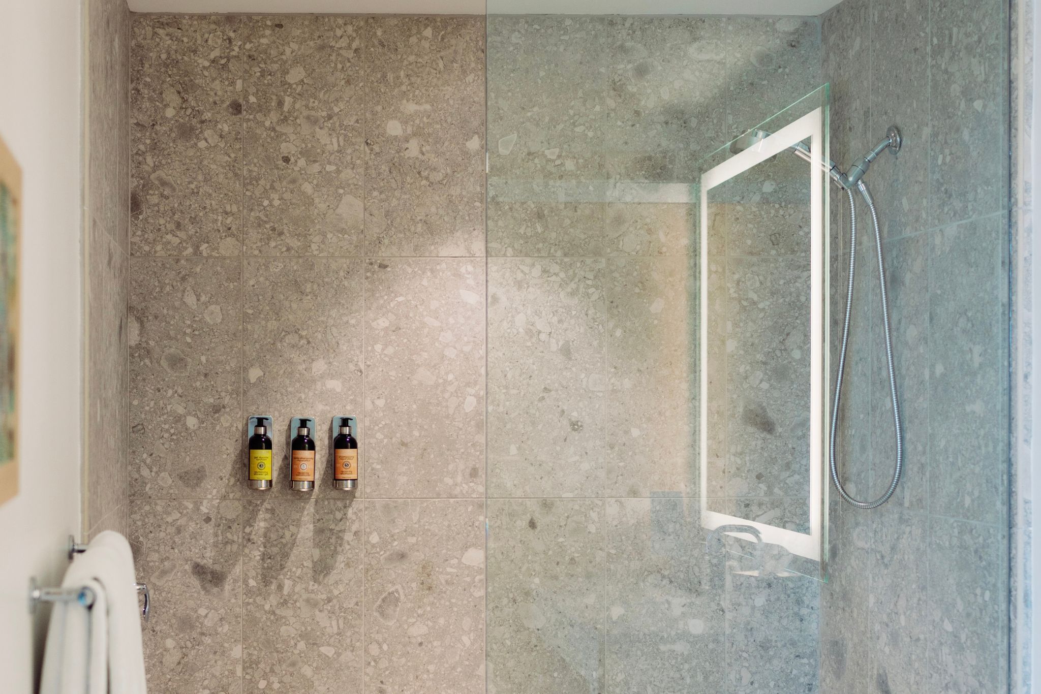 image The spacious shower area exemplifies contemporary design with accessible features, allowing for a comfortable and refreshing experience.