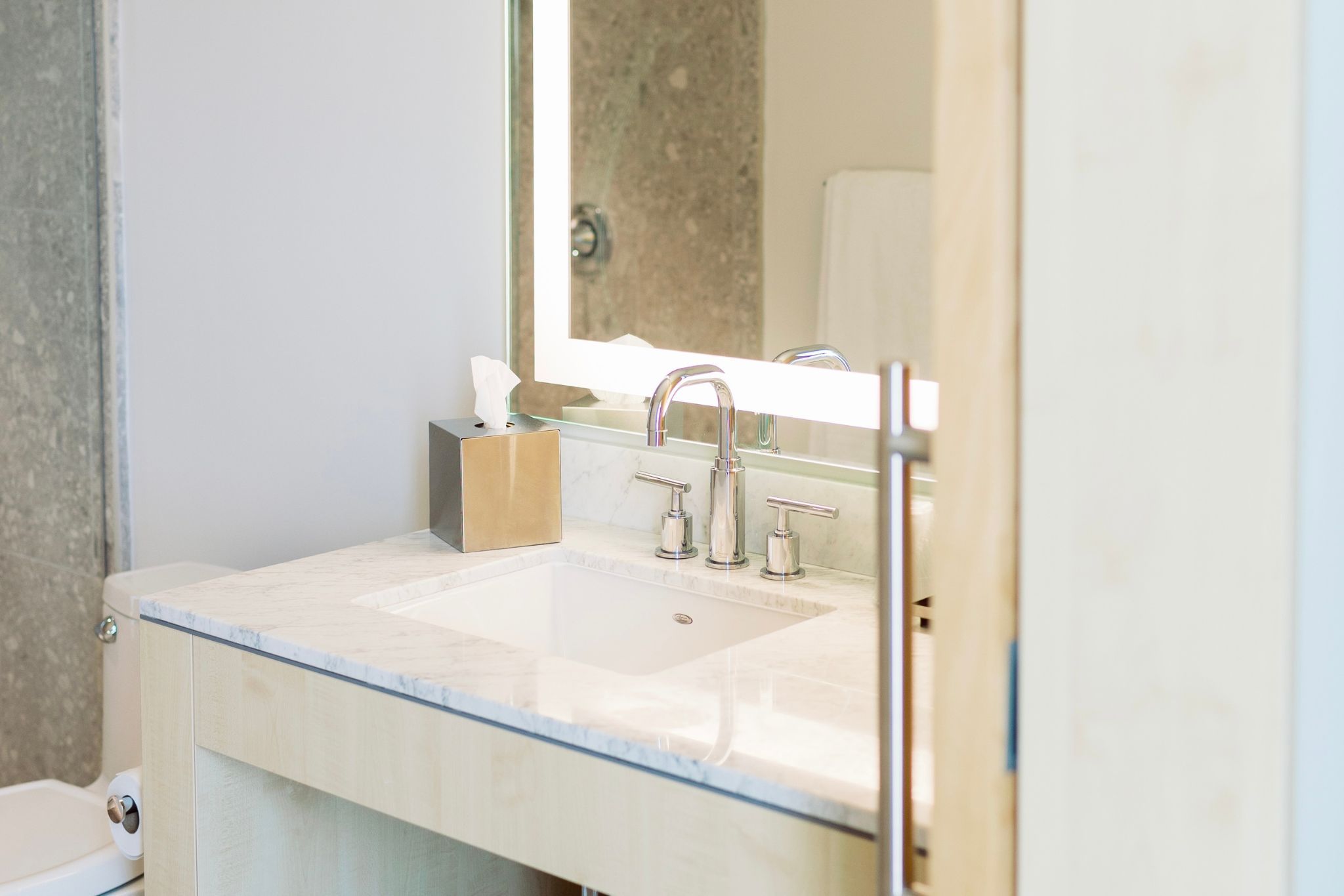image Featuring refined marble and stylish lighting, the bathroom vanity exudes a contemporary charm that enhances daily routines.