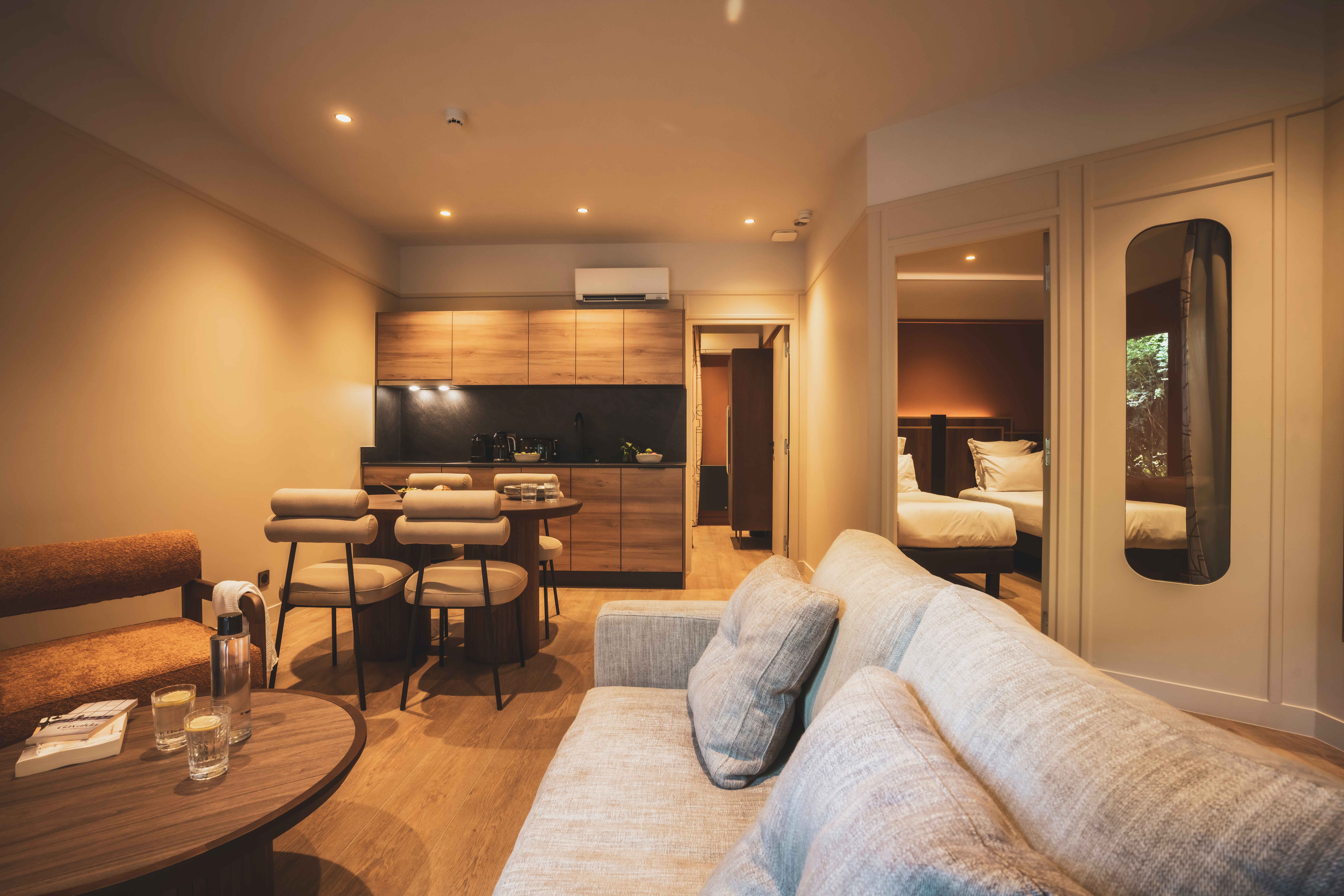 image Spacious open-plan living room blending art-deco design with a cozy, home-like atmosphere.