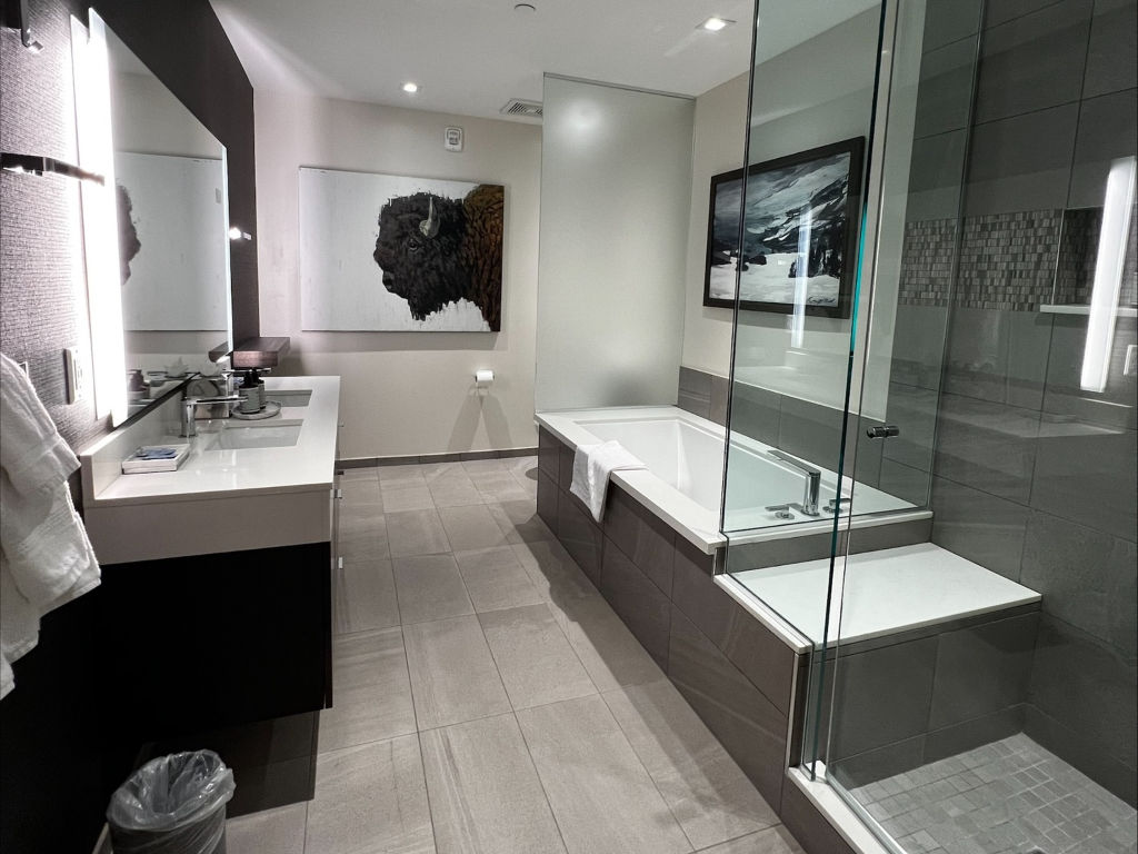 image The luxurious bathroom features a spacious double vanity, a glass-enclosed shower, and a relaxing soaking tub.
