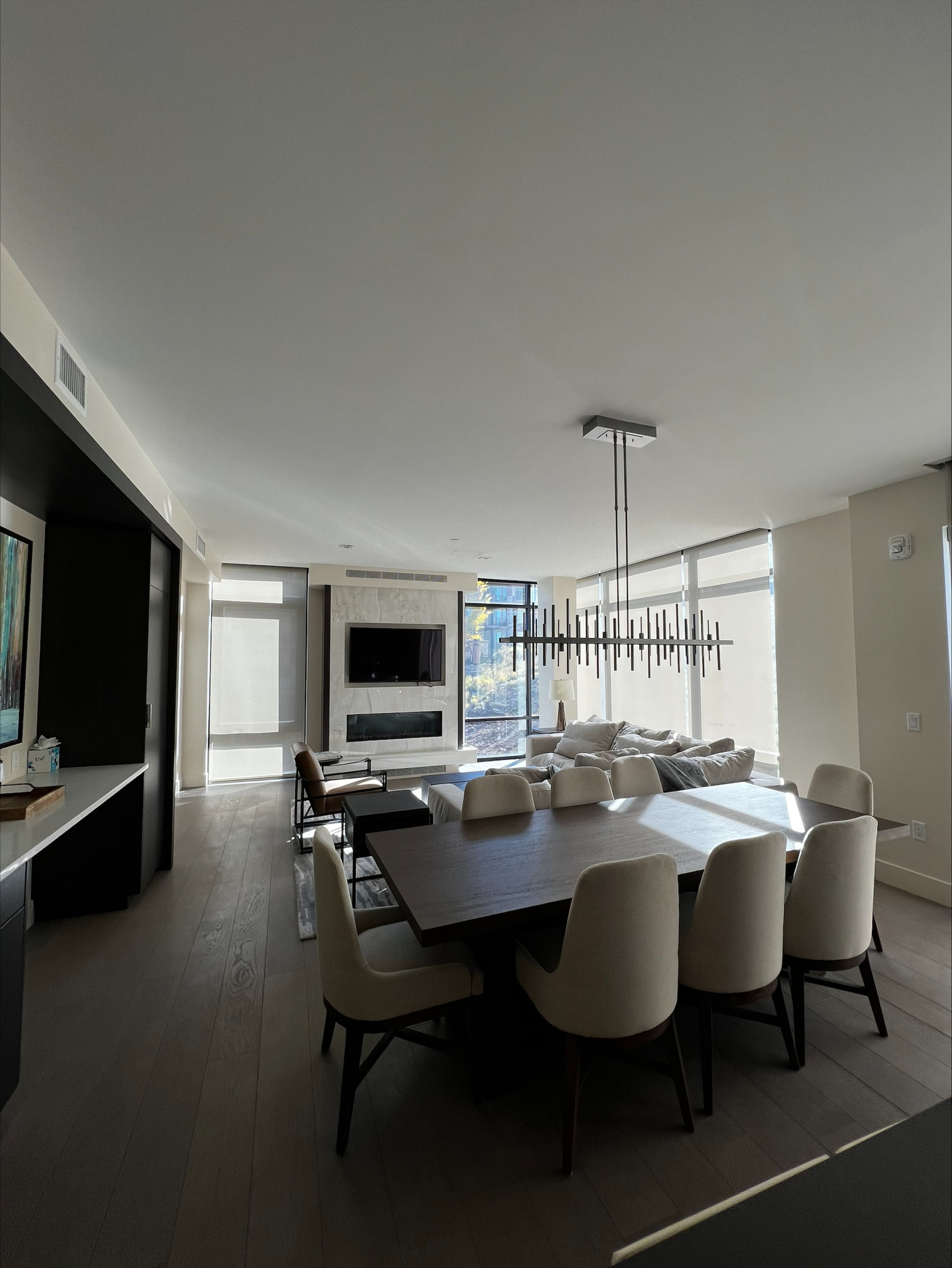 image The spacious living area features a modern fireplace, a stylish dining table, and large windows that fill the space with natural light.