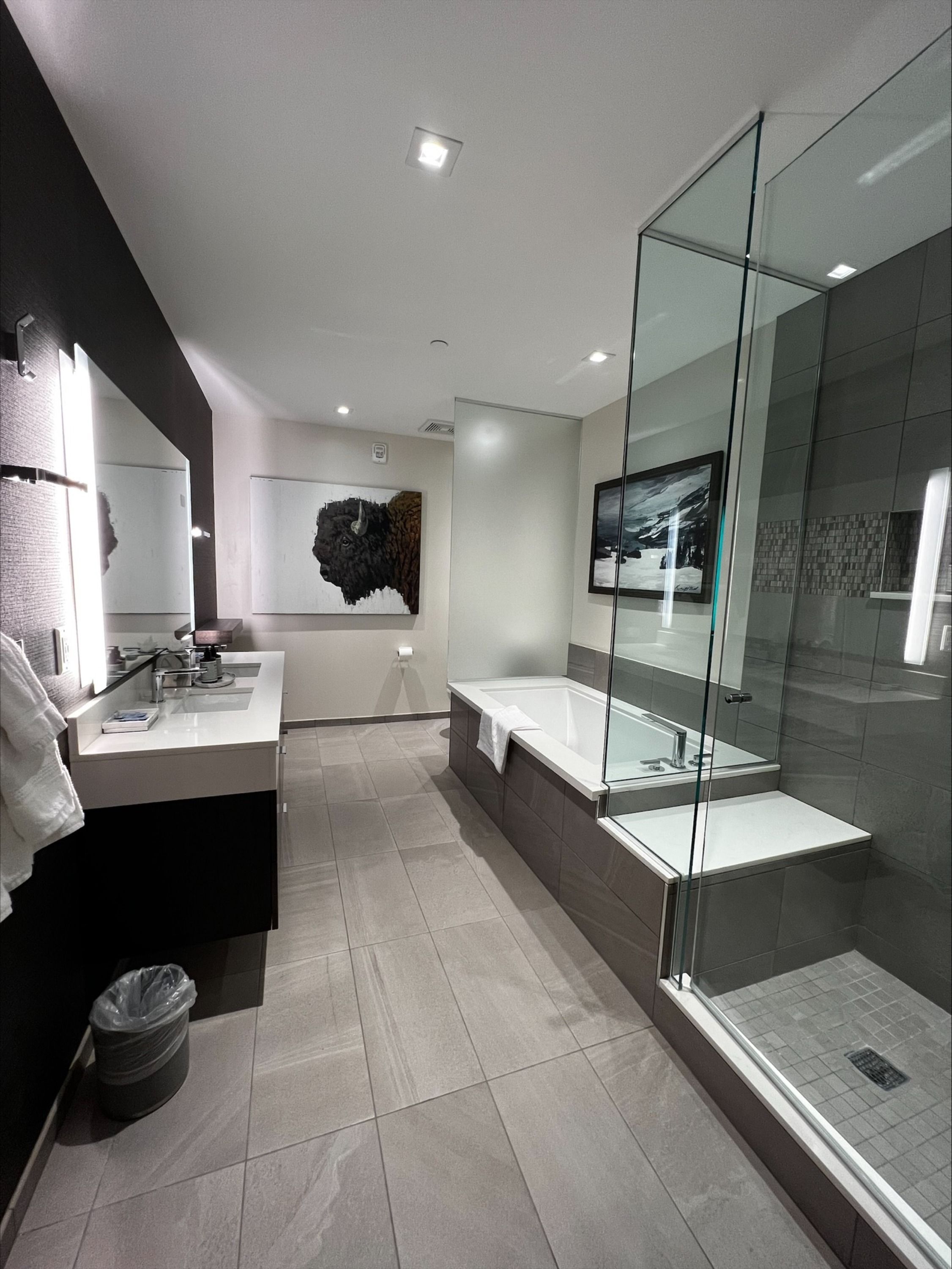 image The luxurious bathroom features a spacious double vanity, a glass-enclosed shower, and a relaxing soaking tub.