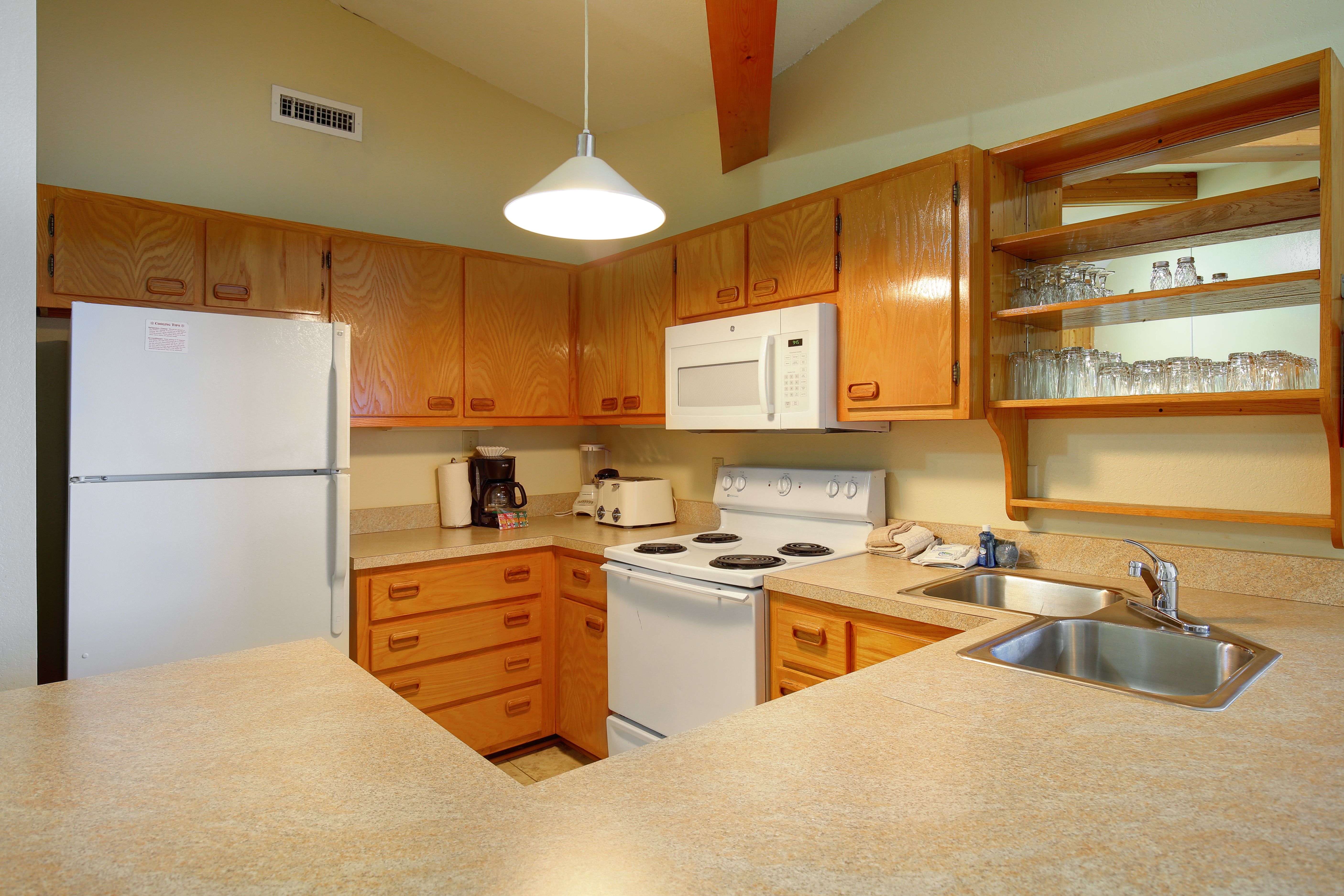 image The fully equipped kitchen offers convenient amenities for preparing meals, with ample counter space for all your culinary adventures.